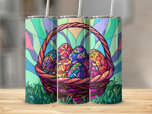 Easter basket filled with stained-glass-style eggs and grass, on a wooden surface.