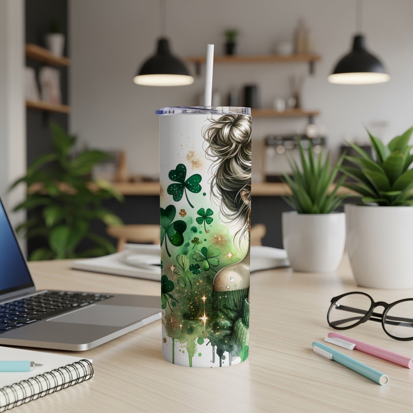 Green tumbler with shamrocks and sparkles, straw in lid.
