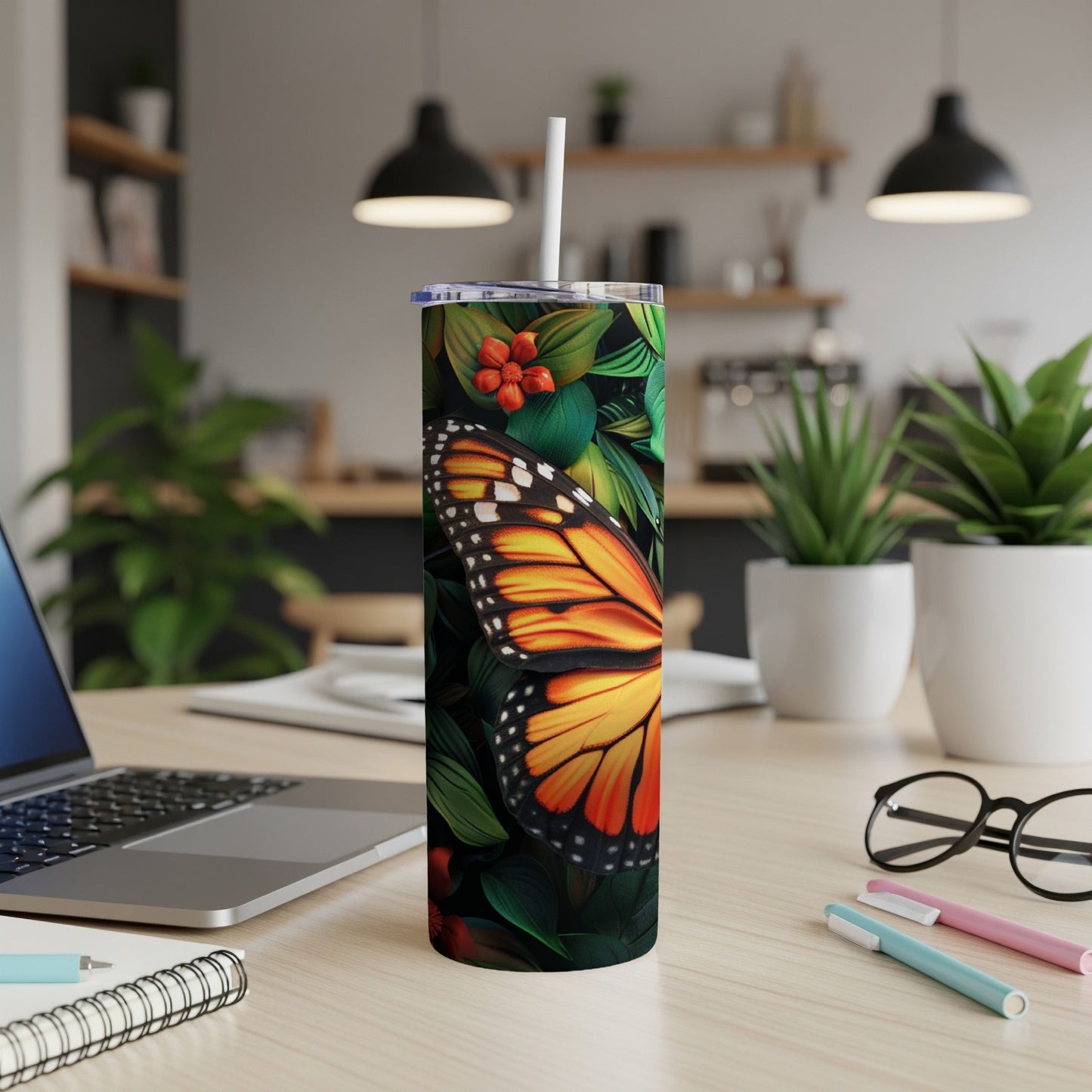 Tall tumbler with orange butterfly and tropical leaves.