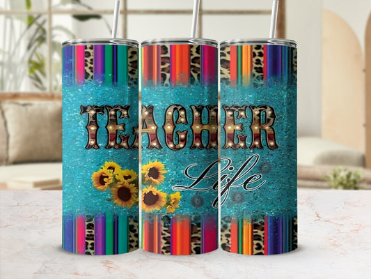 TEACHER Life tumbler with sunflowers and colorful striped pattern.