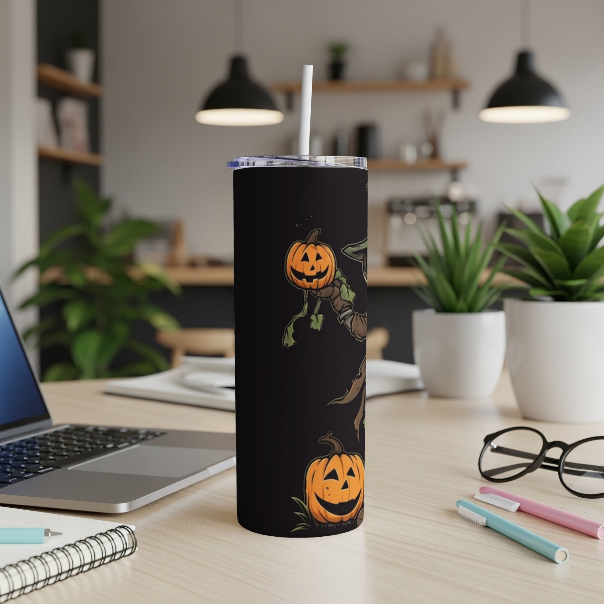 Black tumbler with Halloween scarecrow and pumpkin design and a white straw.
