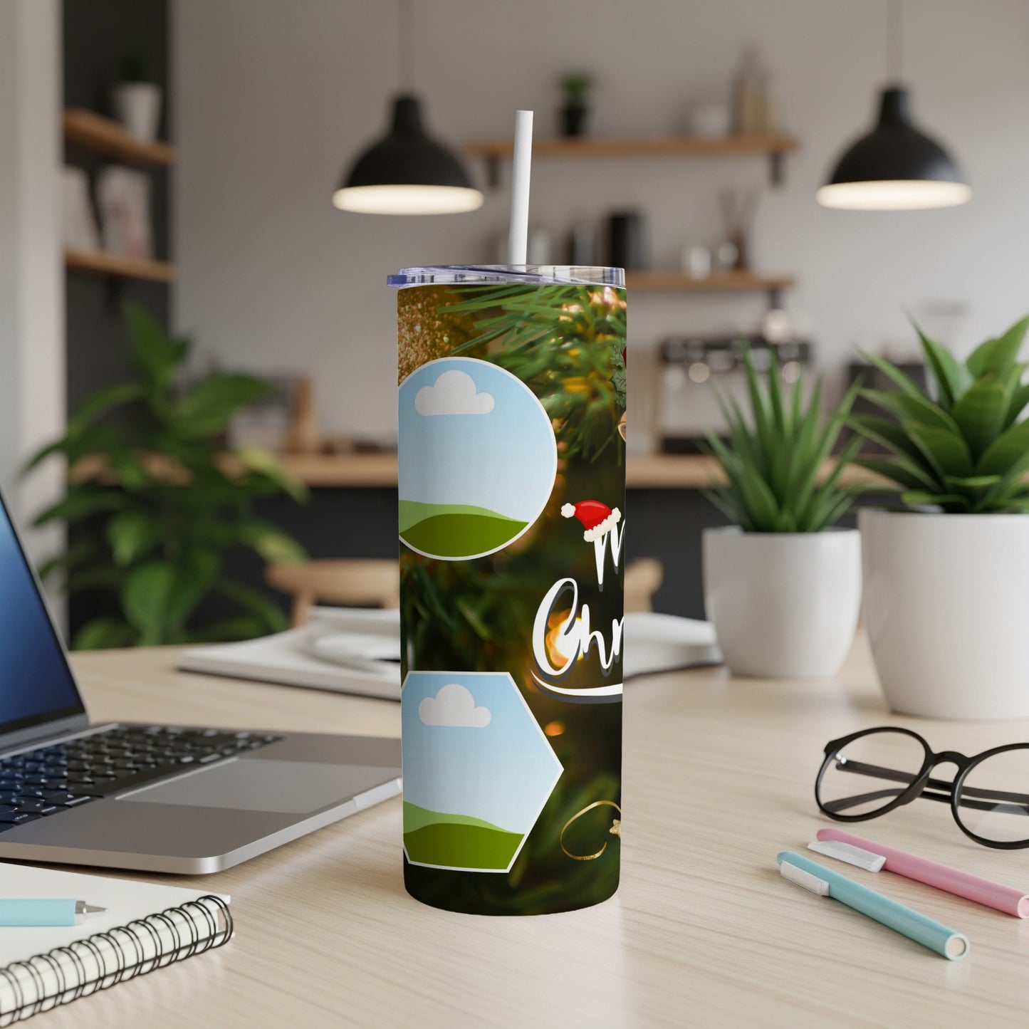 Christmas tumbler with blank photo frames and festive green foliage.