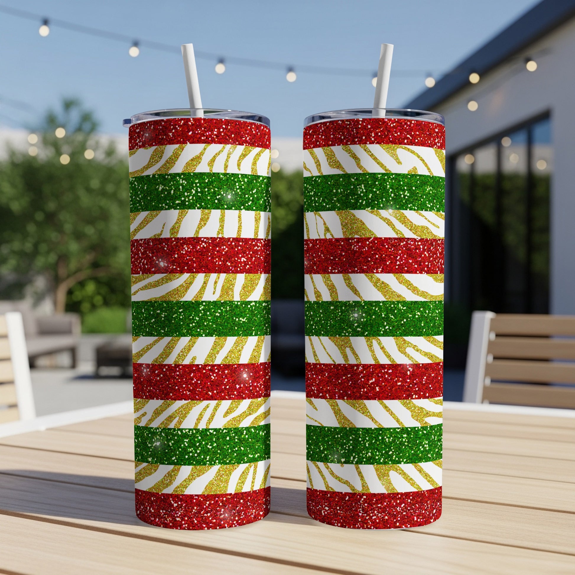 Two tall tumblers with red, green, and gold glitter stripes.
