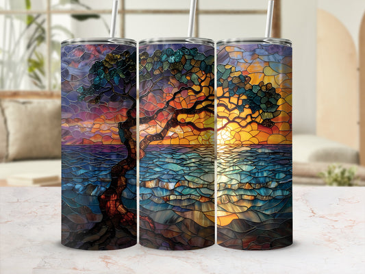 Stained glass tree with sunset reflection on water.