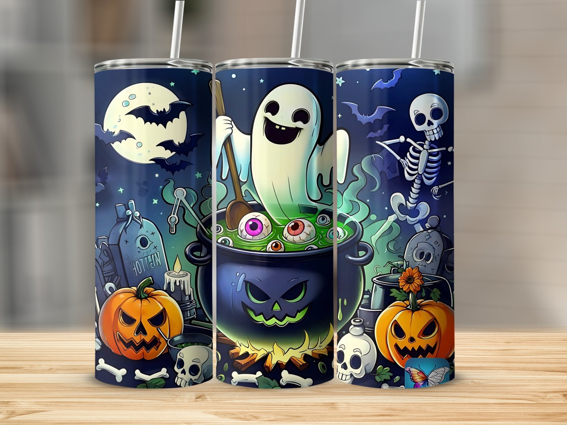Halloween themed tumblers with a ghost, skeleton, pumpkins, and spooky graveyard scene.