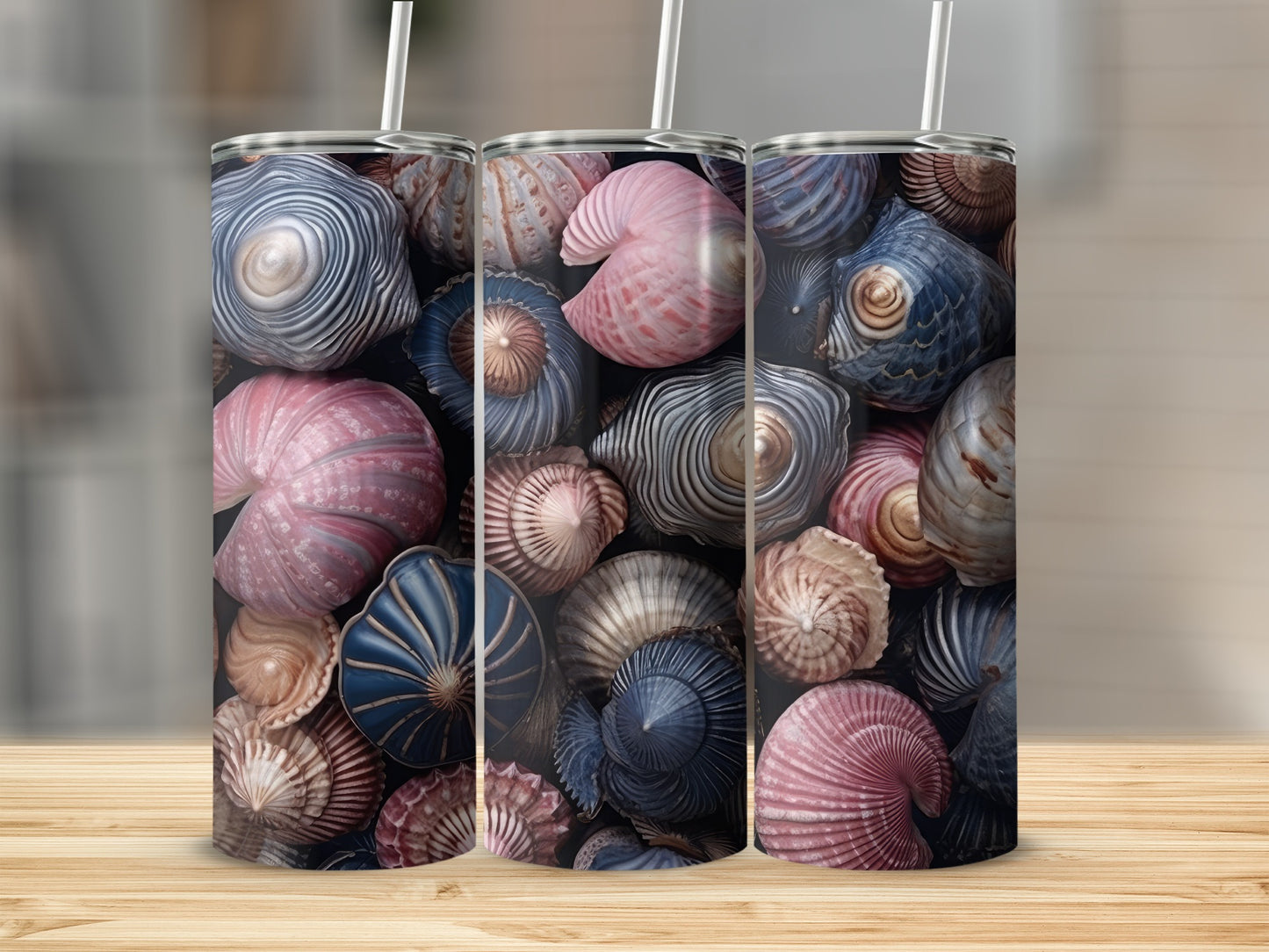 Three tumblers featuring a colorful pattern of various seashells.