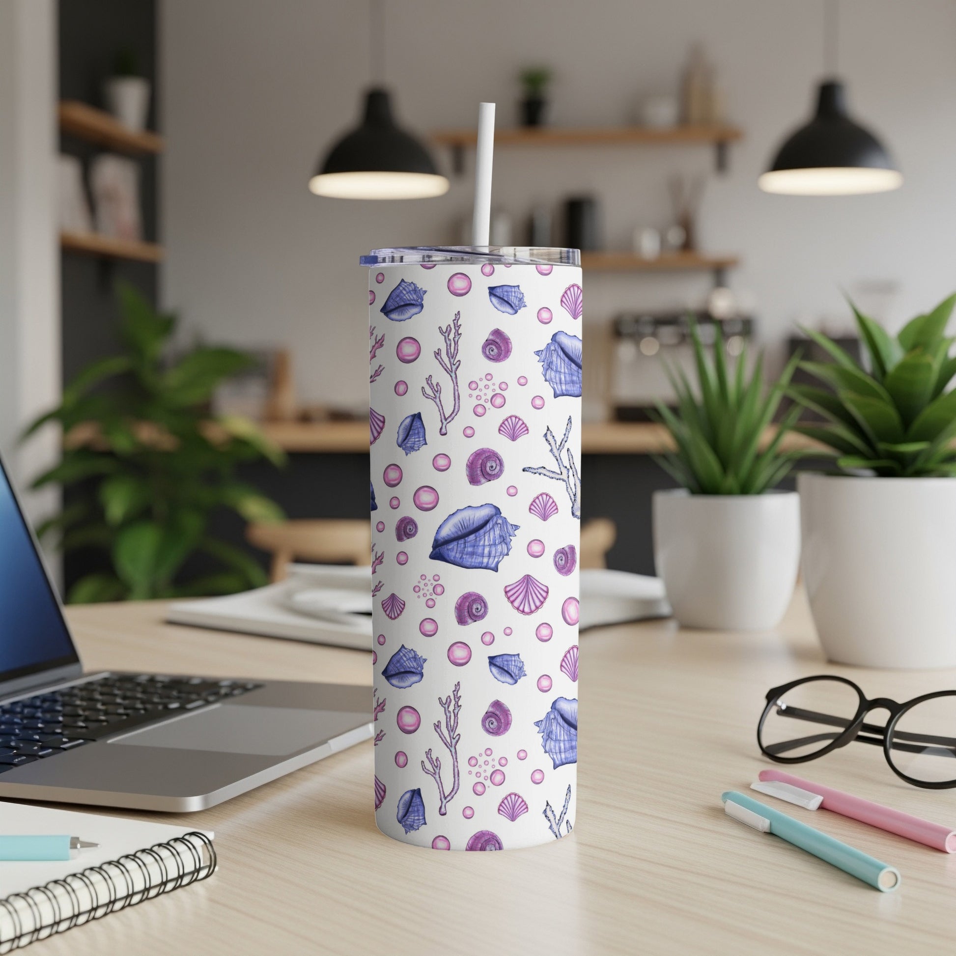 White tumbler with purple seashells, starfish, and coral pattern.