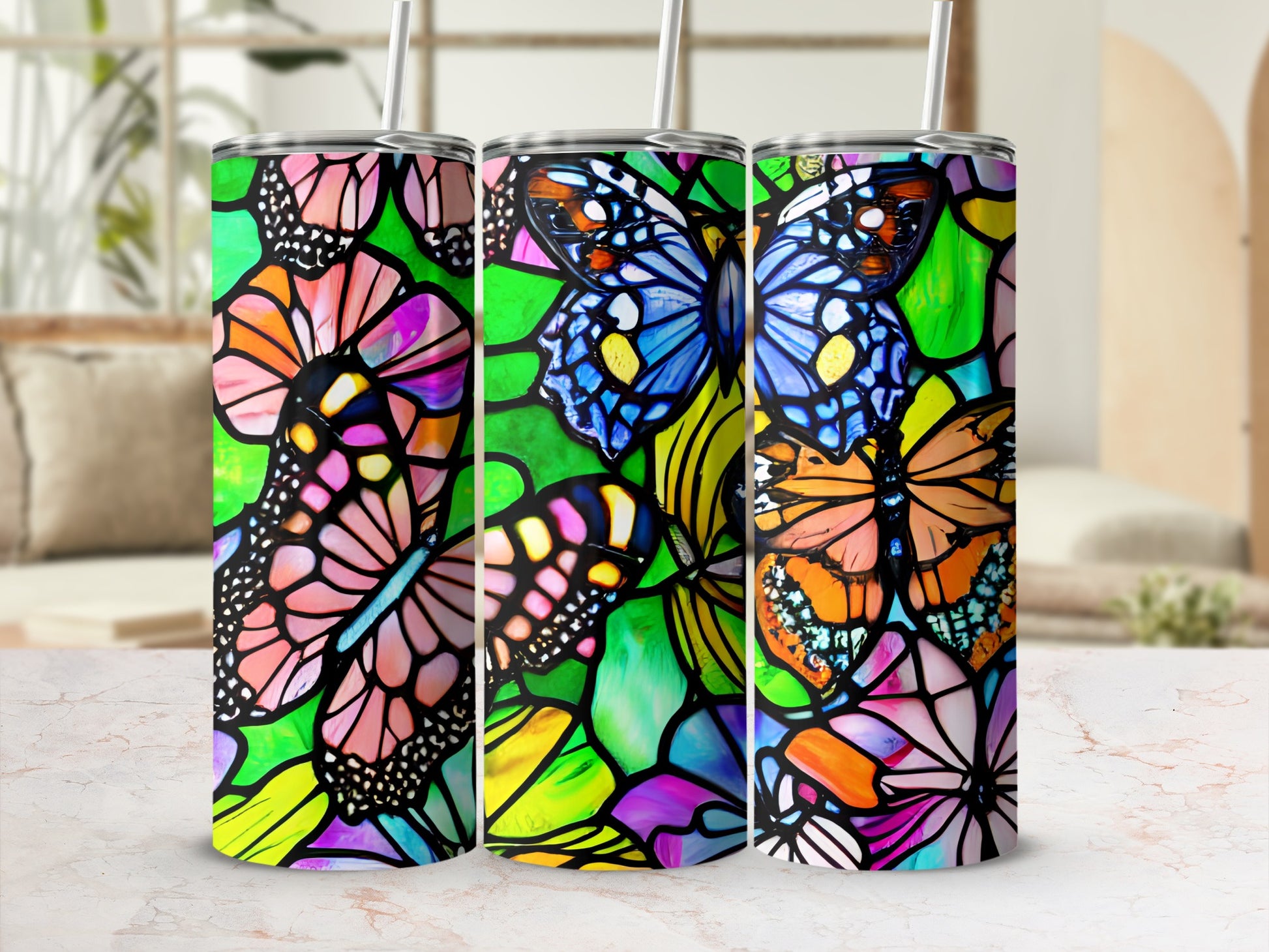 Three tumblers with vibrant stained-glass butterfly designs.