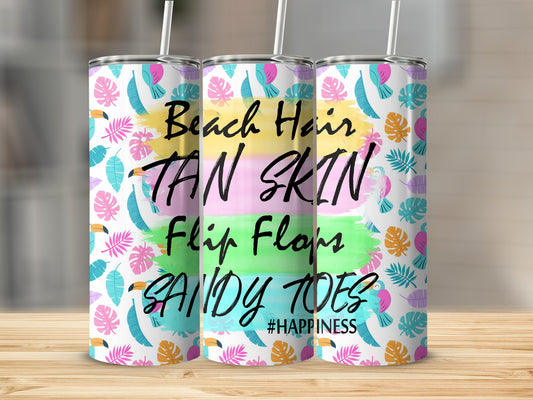 Tumbler with "Beach Hair Tan Skin Flip Flops Sandy Toes #Happiness" text and tropical leaves.