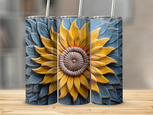 Sunflower tumbler with straw on a wooden surface.