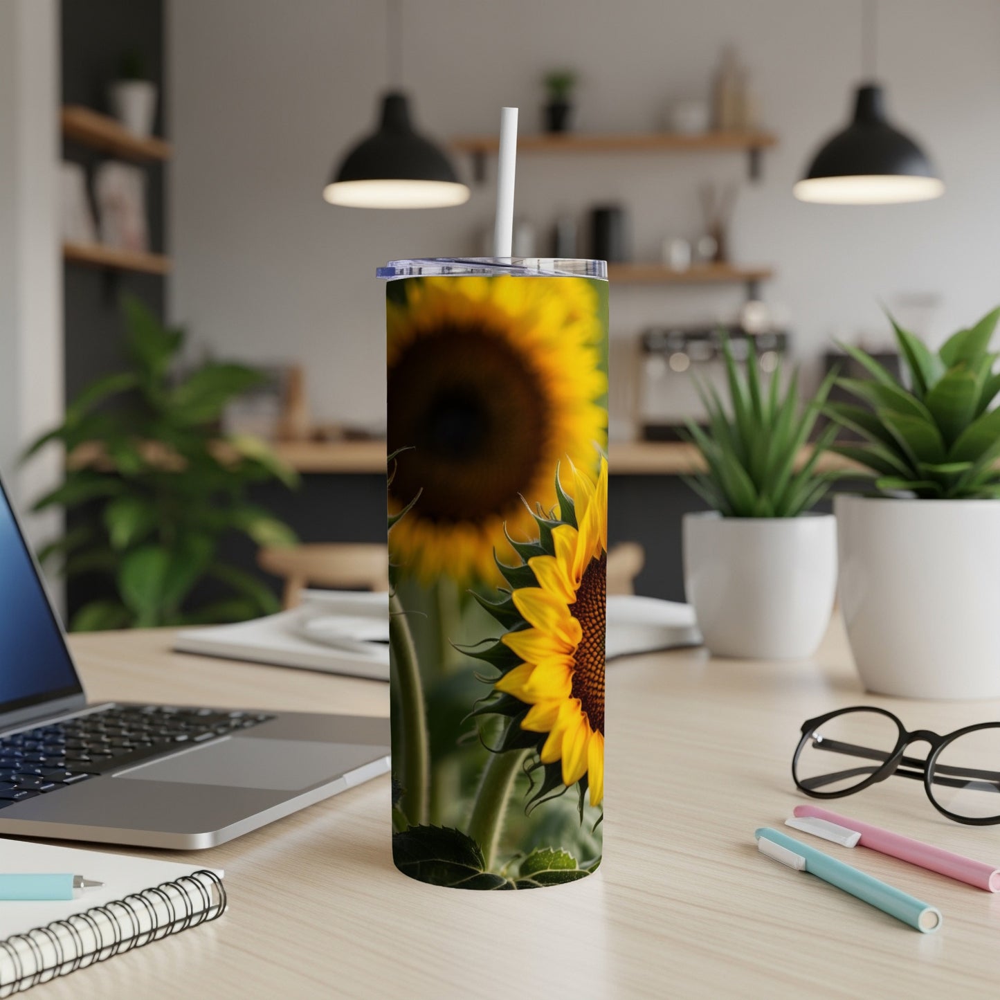 Tall tumbler with close-up sunflower design on a desk.