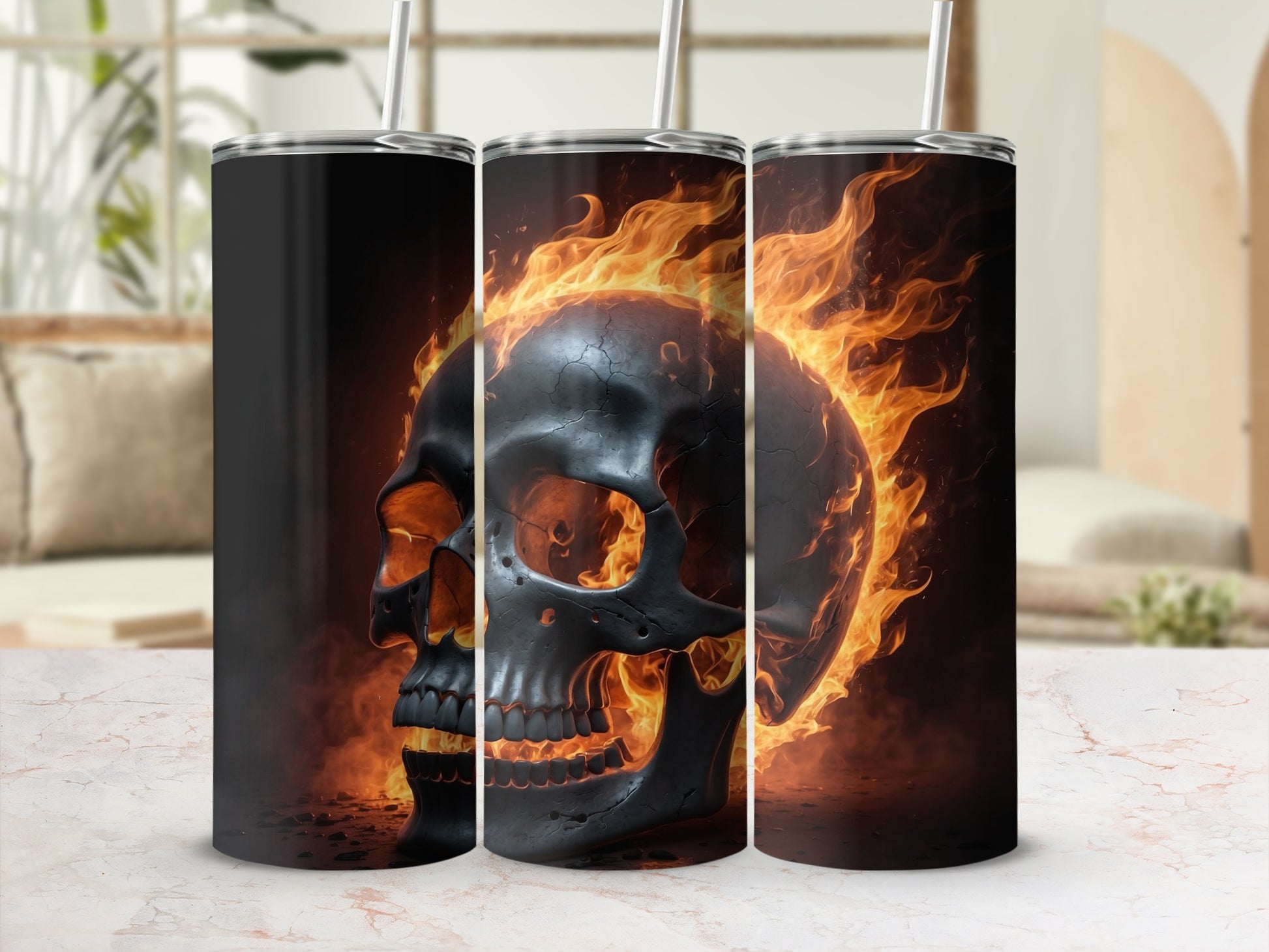 Three tumblers featuring a fiery skull design on a marble countertop.