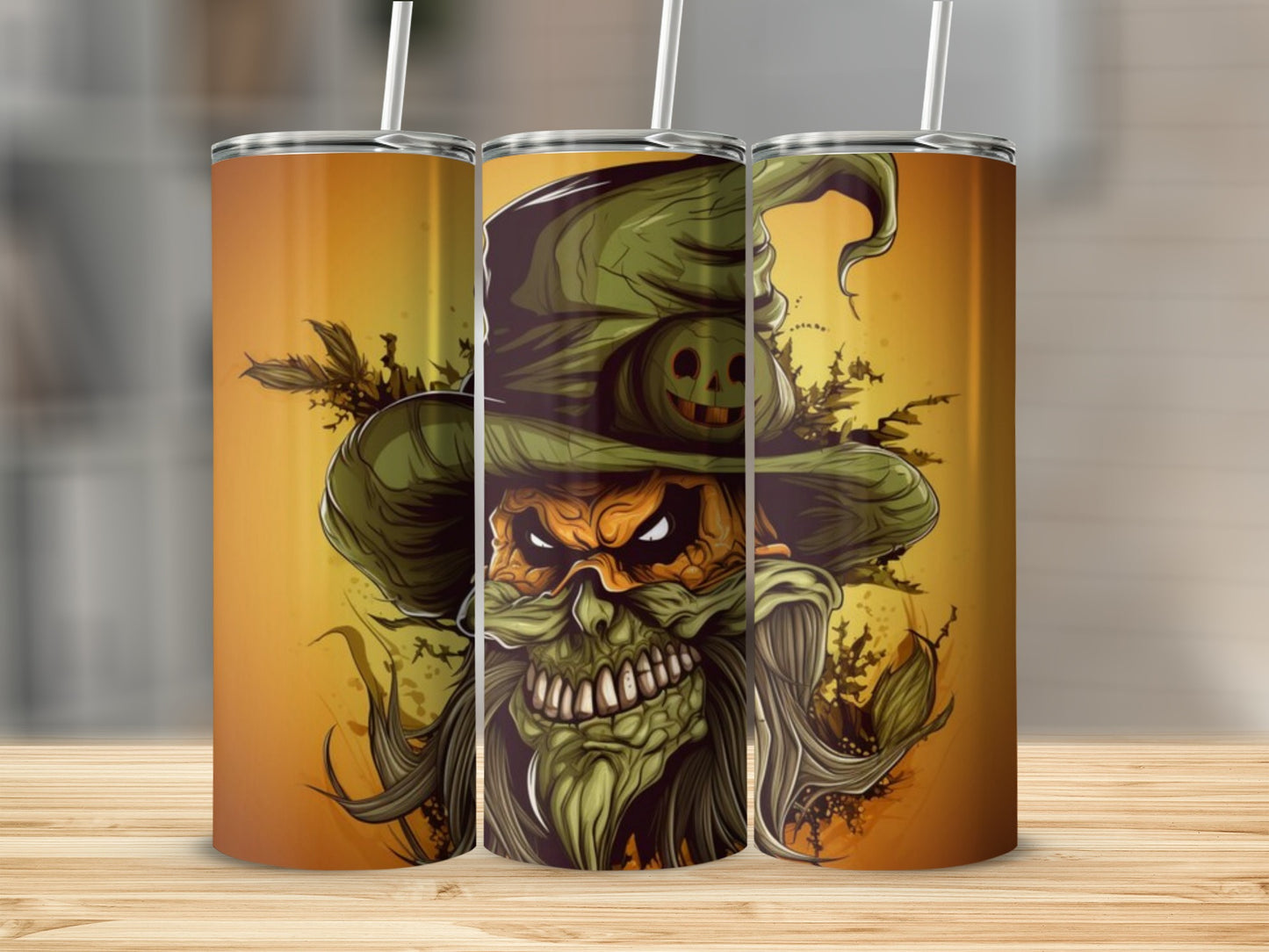 Three tumblers with a Halloween scarecrow design on an orange background.