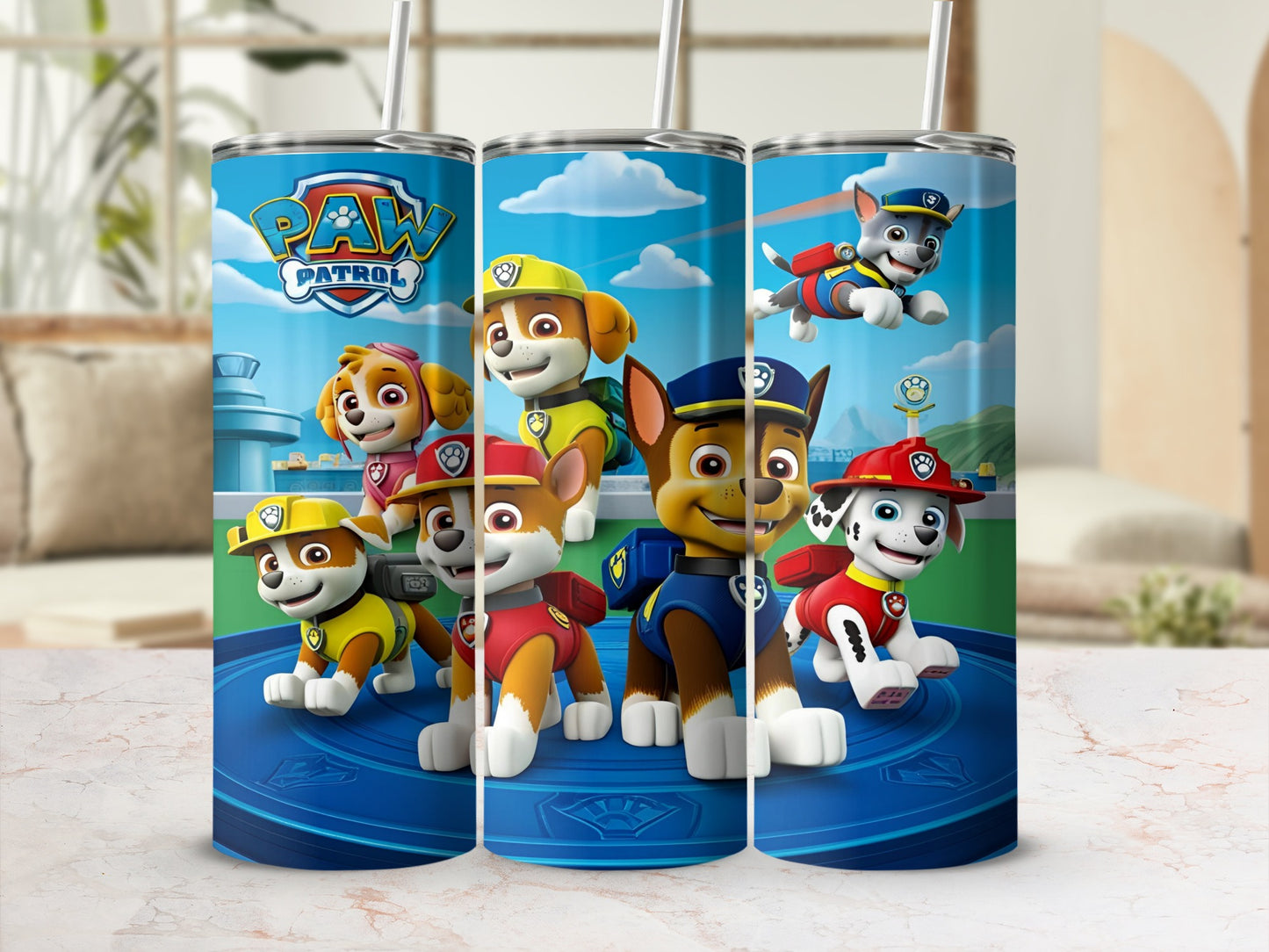 Paw Patrol characters Chase, Marshall, Skye, and Ryder on a blue cylindrical tumbler.
