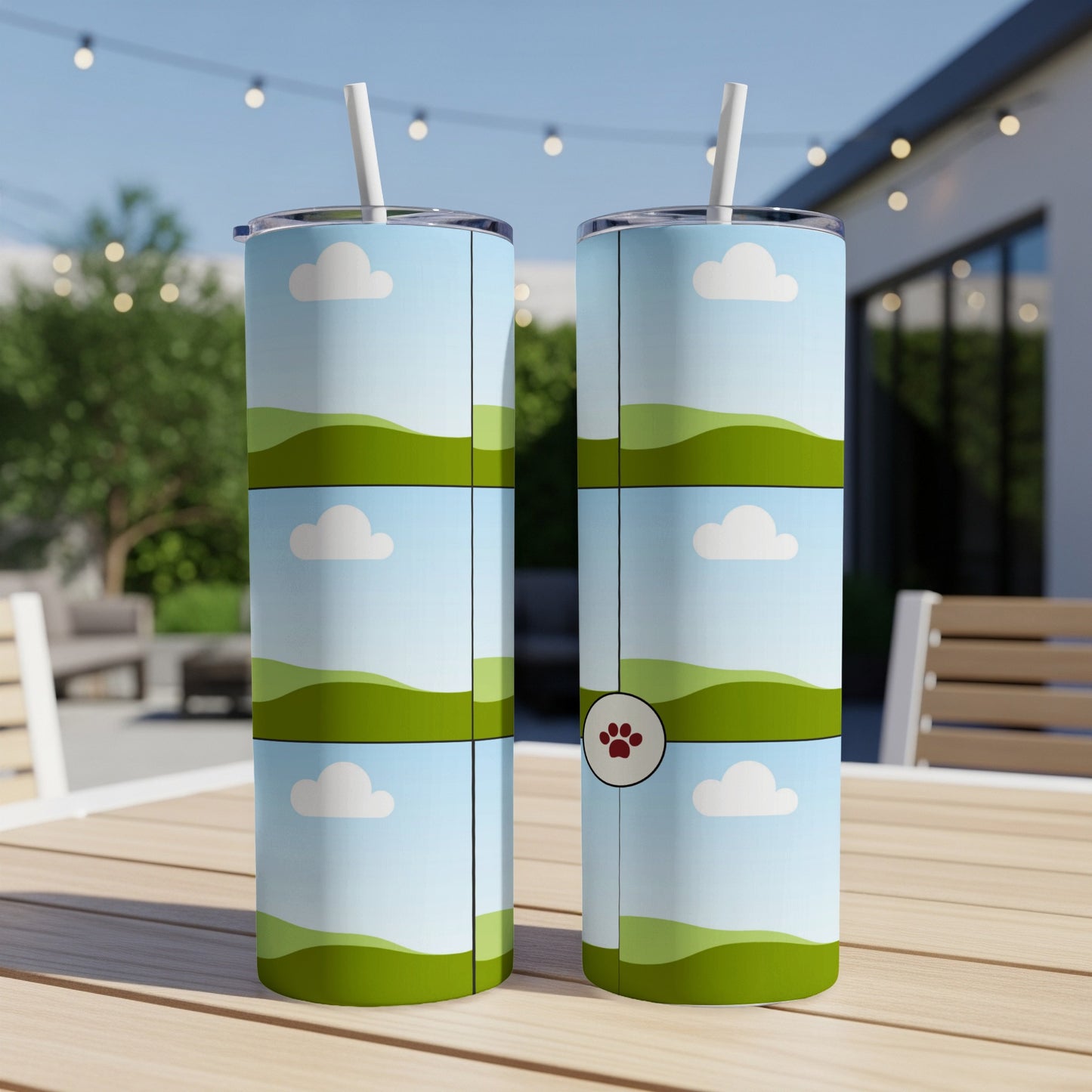 Two tumblers with a stylized landscape design featuring clouds and green hills.