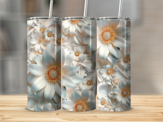 Three tumblers with a detailed floral pattern and straw, set on a wooden surface.