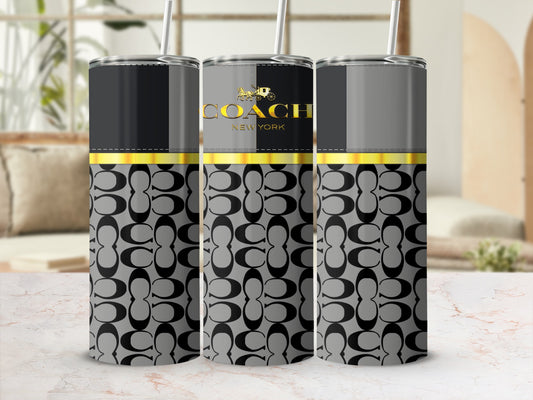 Coach New York logo on a gray and black tumbler with signature pattern.