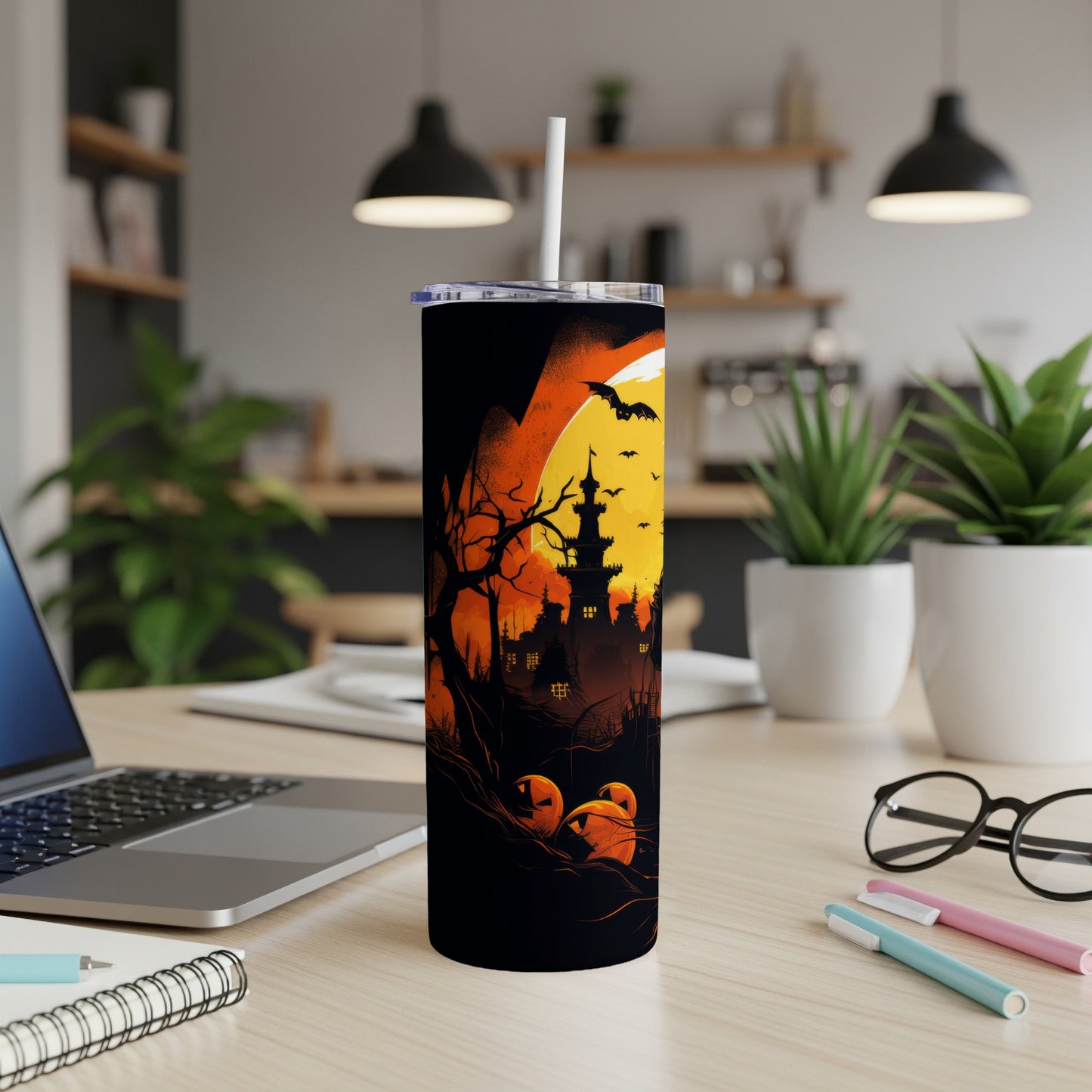 Halloween themed tumbler with haunted castle, pumpkins, and bats against a full moon.