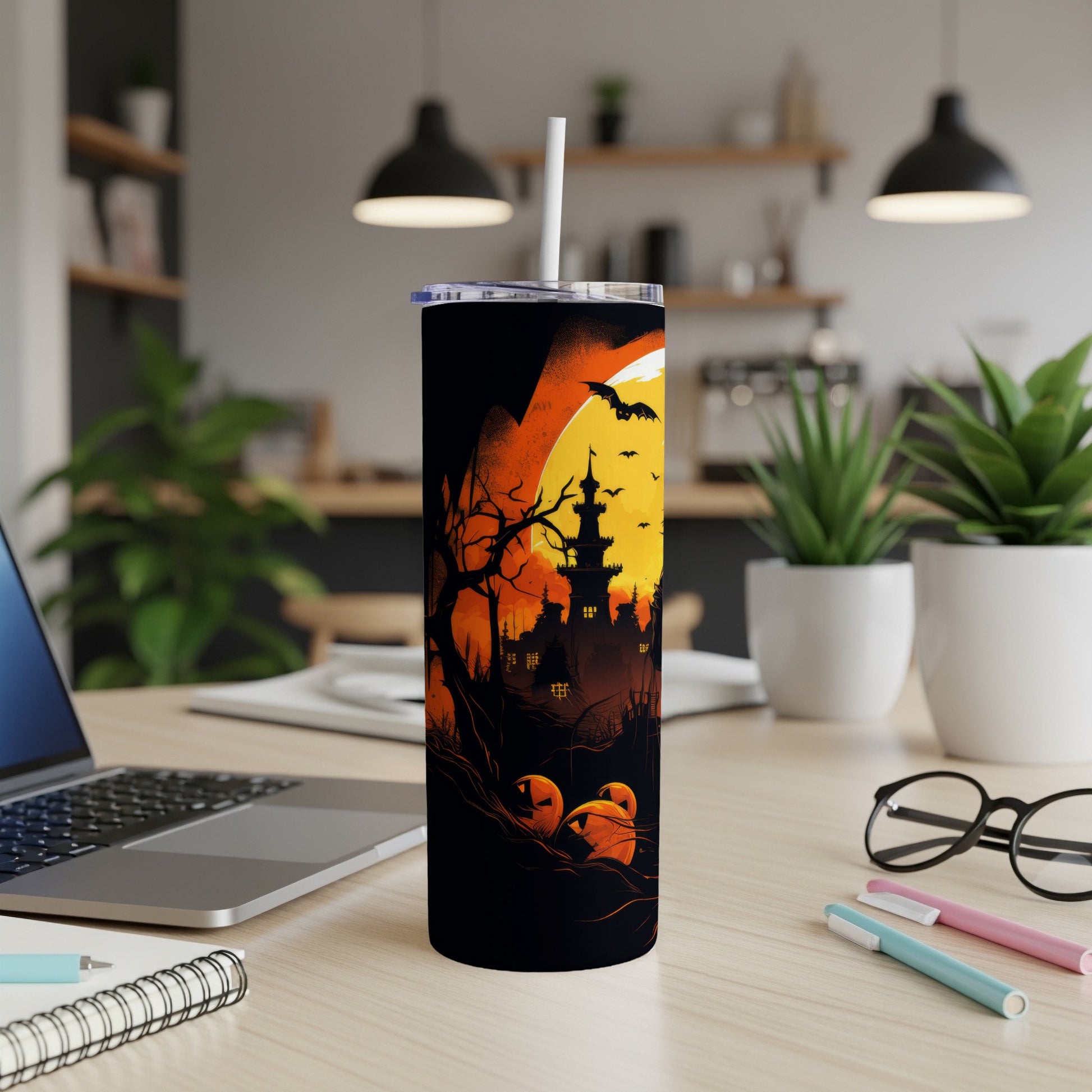 Halloween themed tumbler with haunted castle, pumpkins, and bats against a full moon.