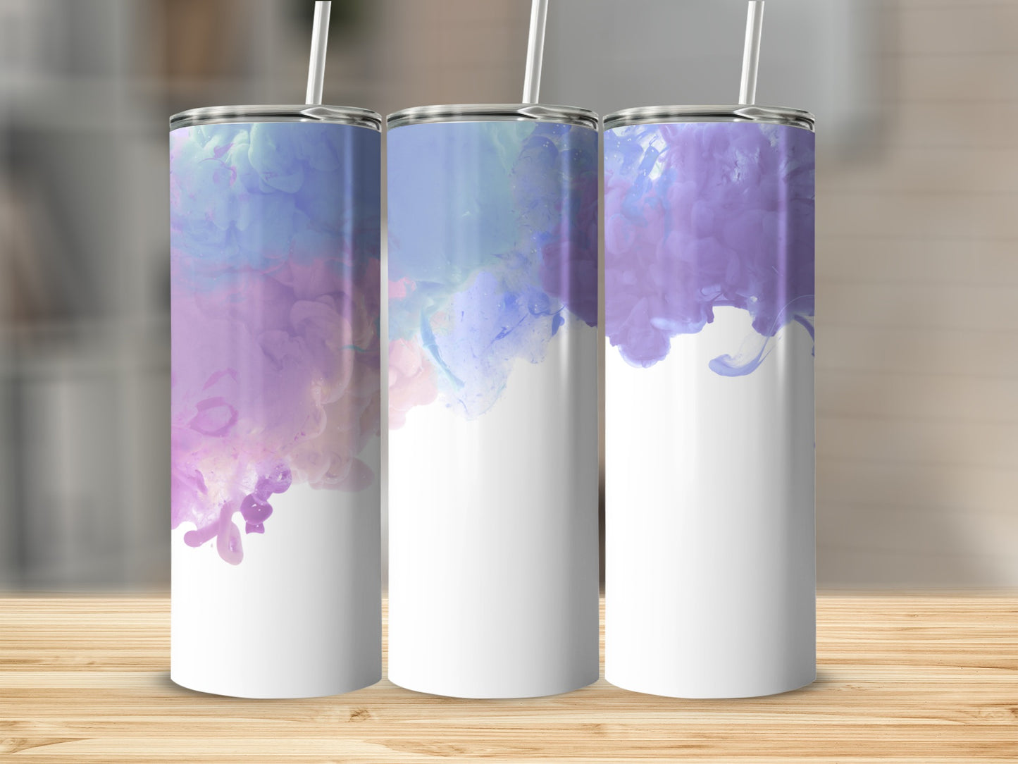 Three white tumblers with purple and blue watercolor designs and straws.