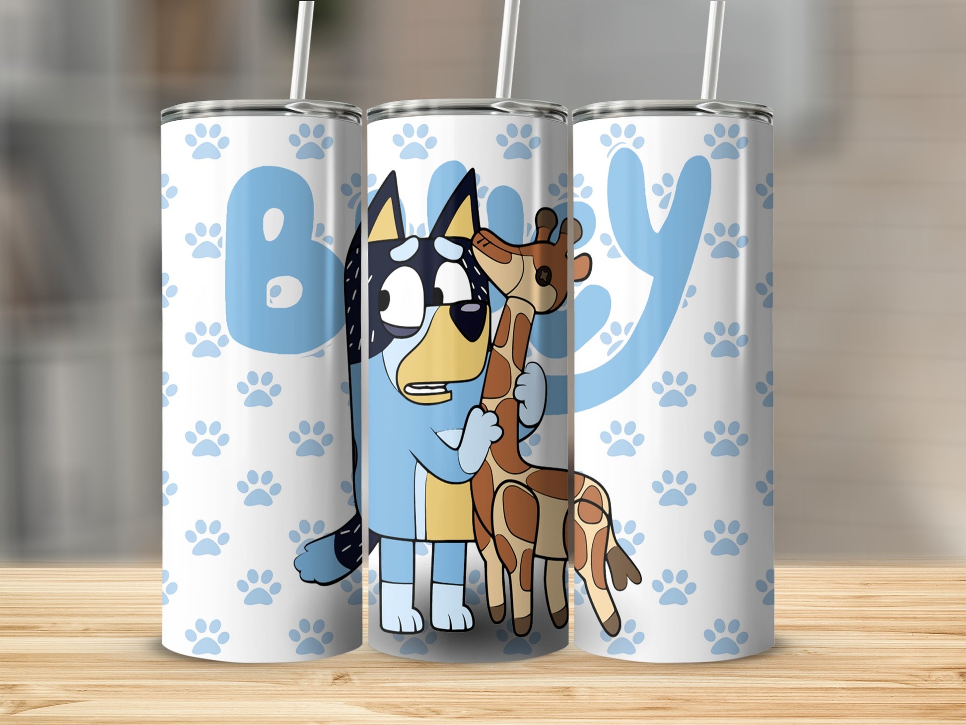 Bluey and Bingo characters hugging a giraffe on a white tumbler with blue paw prints.