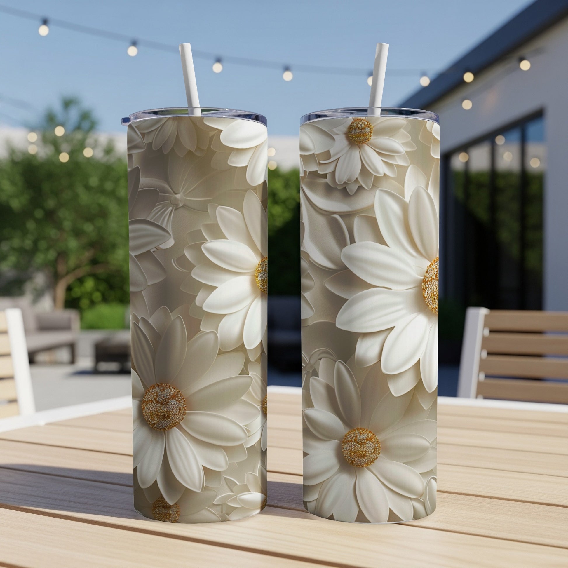 Two tumblers with white floral designs sit on a wooden table.