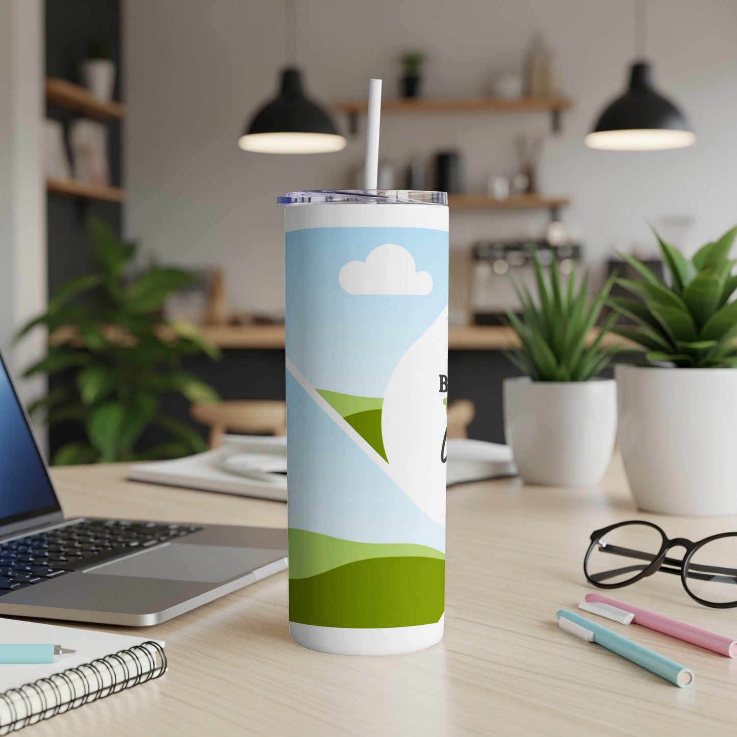 White tumbler with blue sky, white clouds, and green hills design.