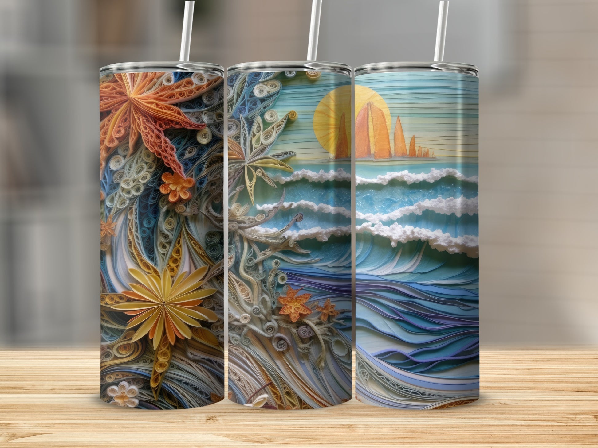 Three tumblers with a rolled paper art scene of a beach with waves and sunset.