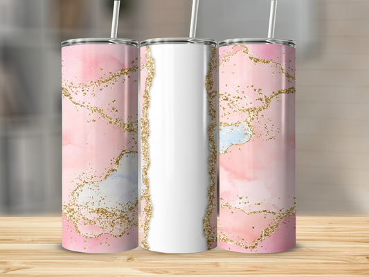 Pink marble tumbler with gold glitter accents on a wooden surface.