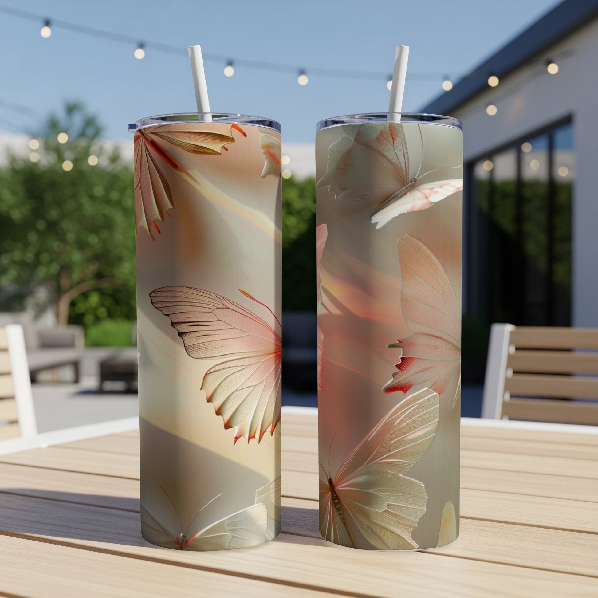 Two tall tumblers with iridescent butterfly designs sit on a wooden table.