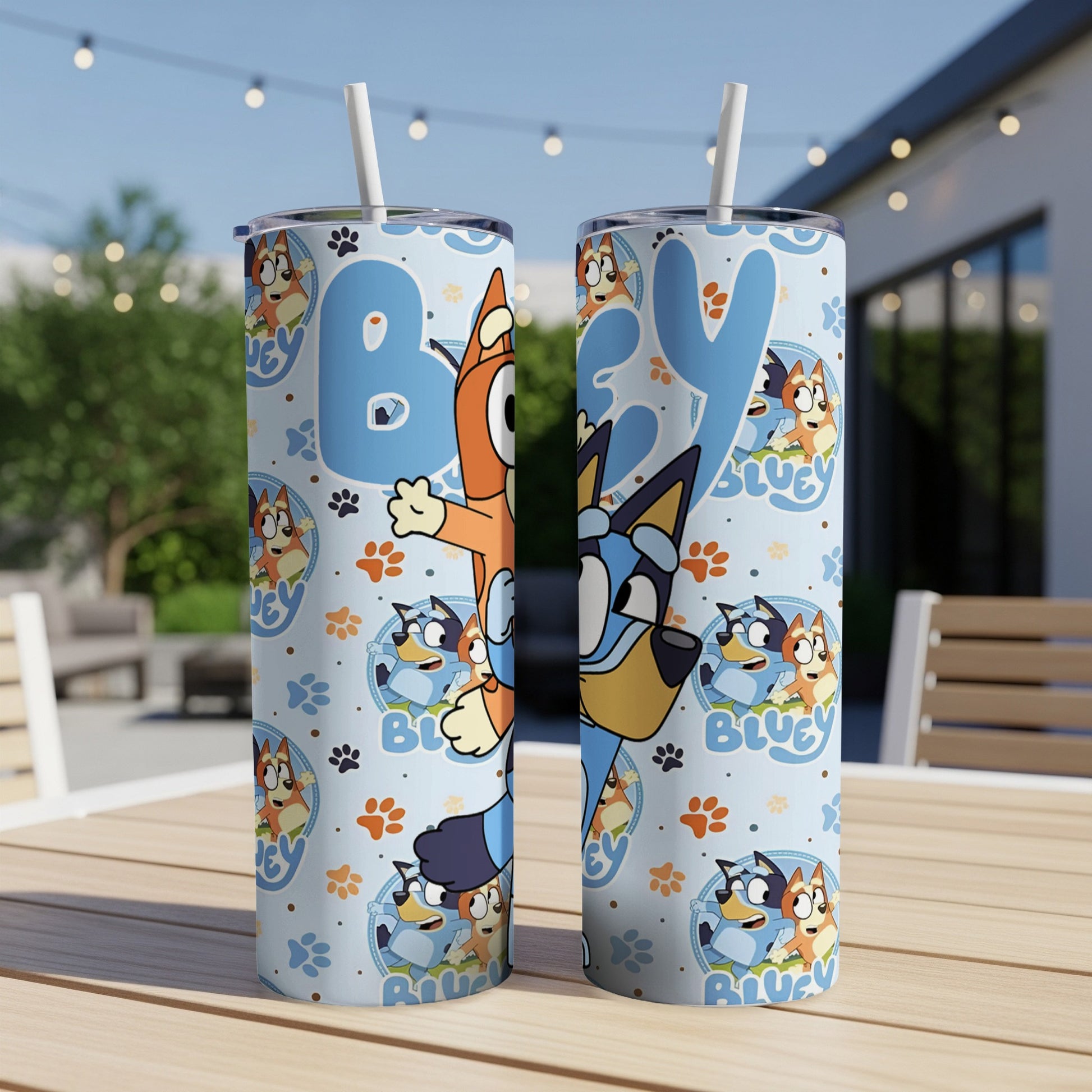 Bluey and Bingo characters on blue patterned tumbler with straws.