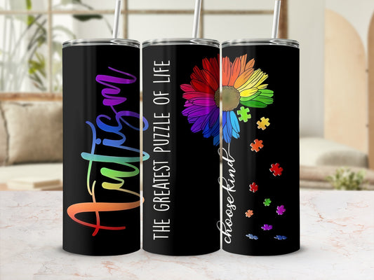 Black tumbler with rainbow autism puzzle flower and quote.