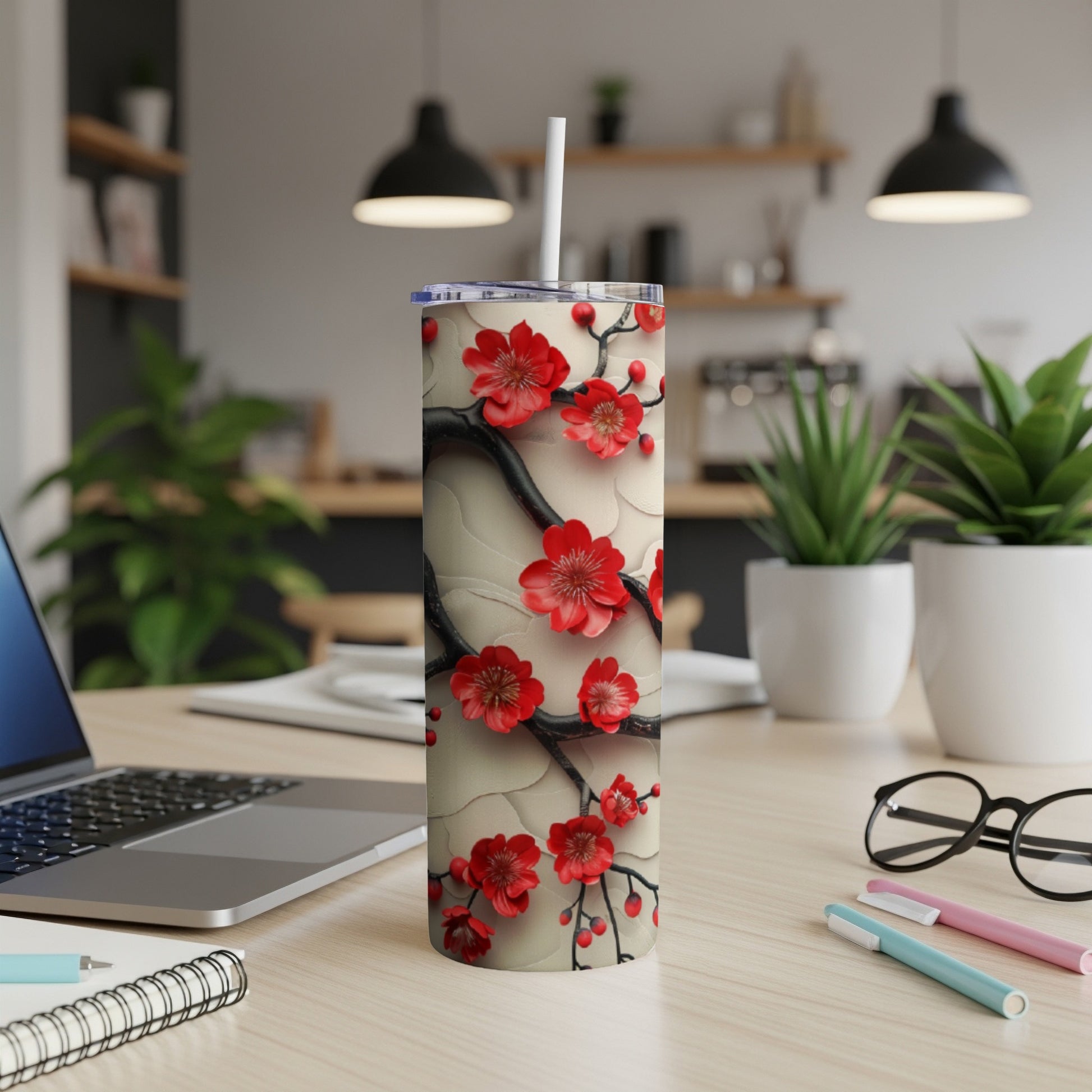 Red cherry blossoms on a textured white tumbler with a straw.