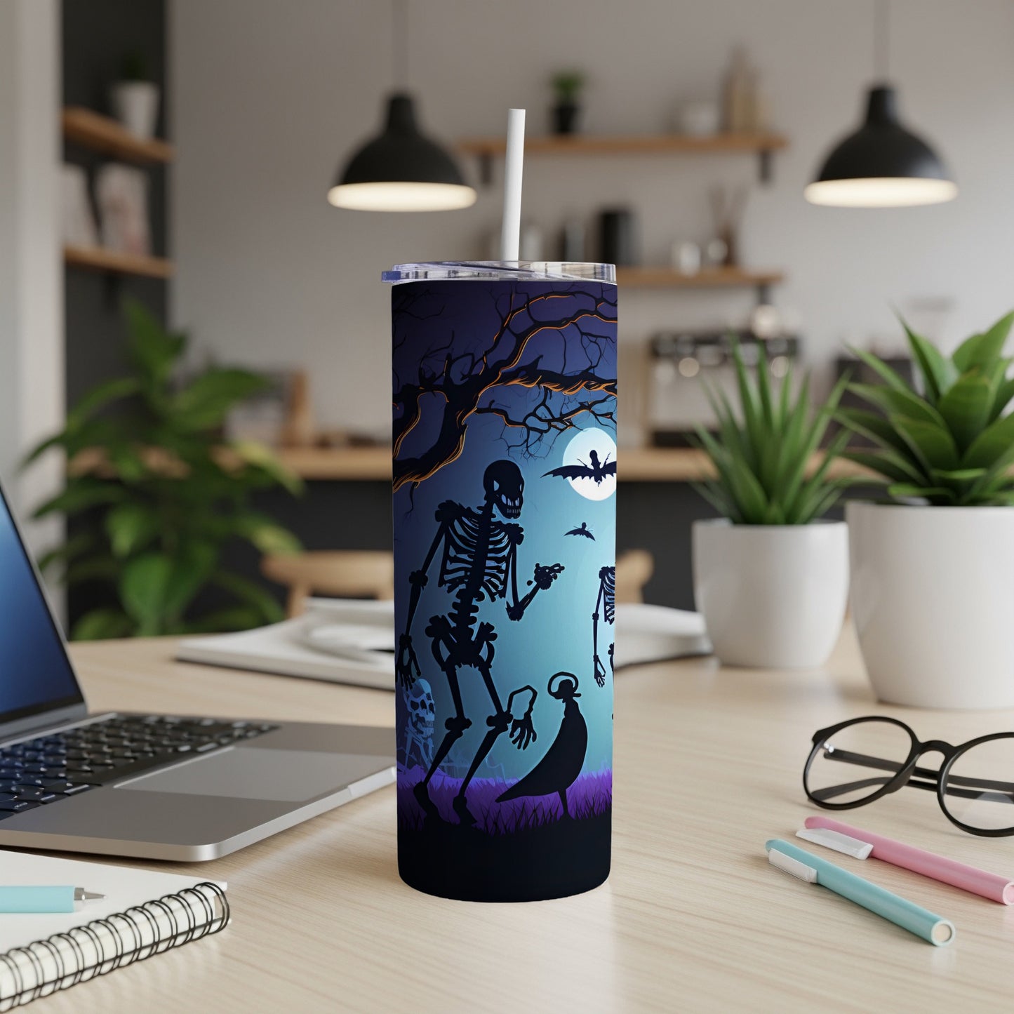 Tumbler with Halloween skeleton, bat, and crow silhouette design on a dark, moonlit background.