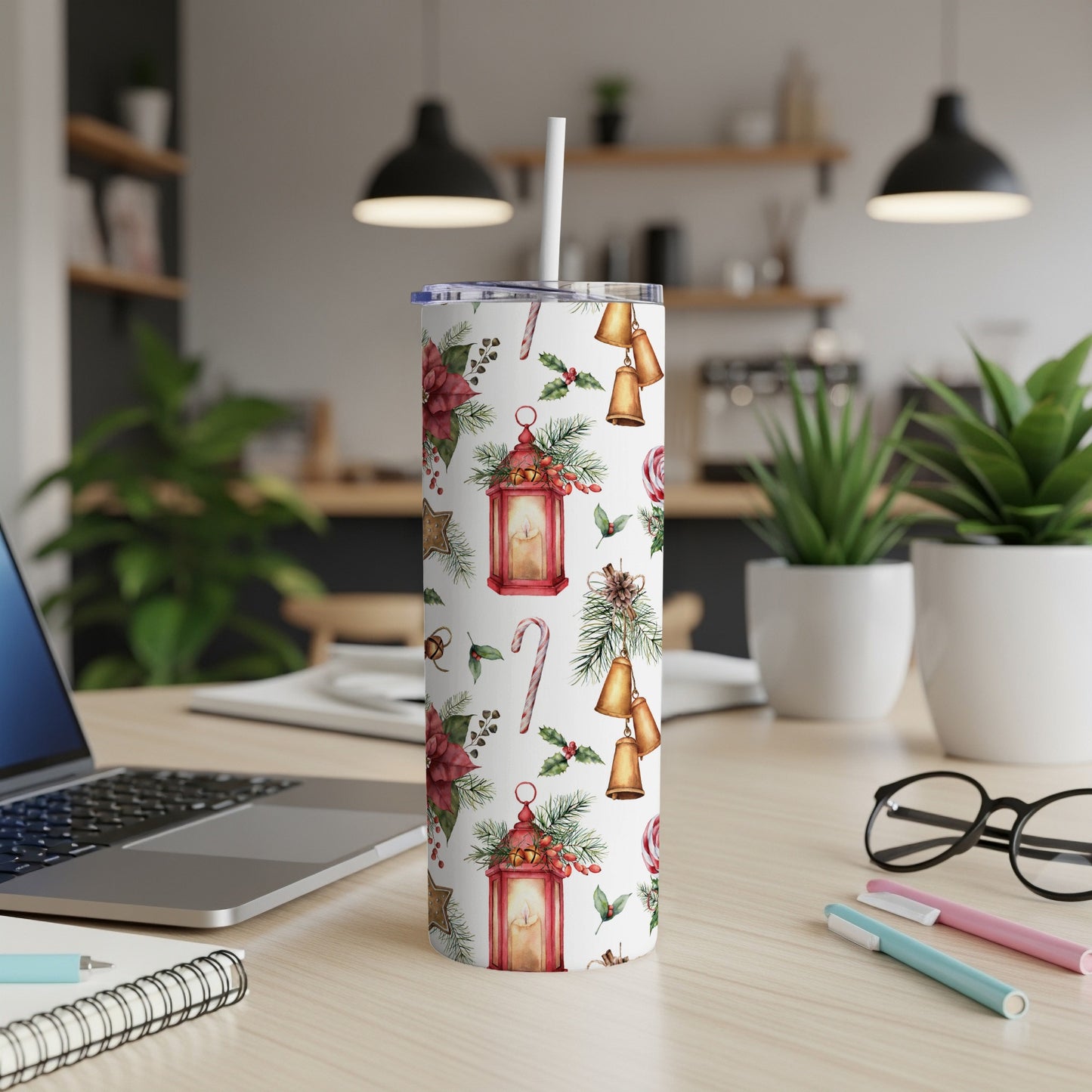 White tumbler with Christmas lantern and bell pattern, straw inserted.