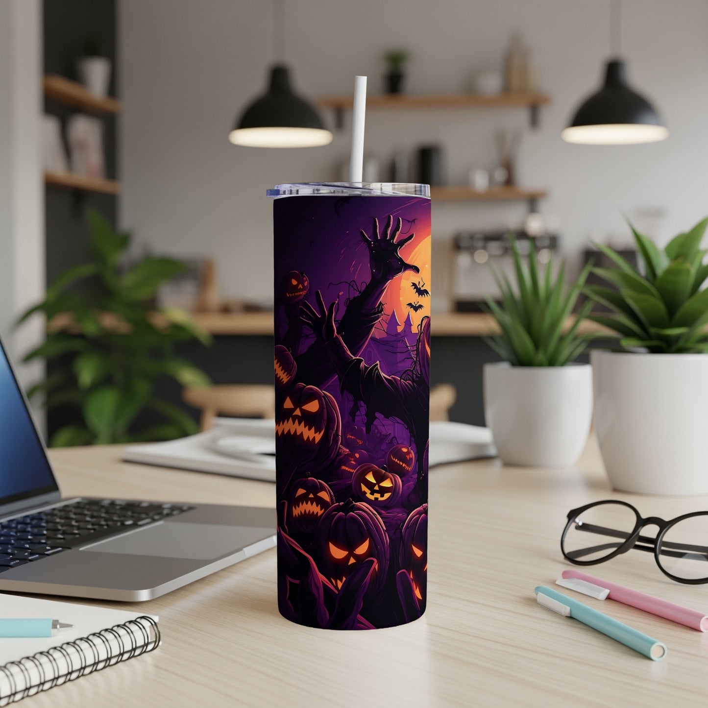 Halloween tumbler with jack-o'-lanterns and a spooky monster illustration.