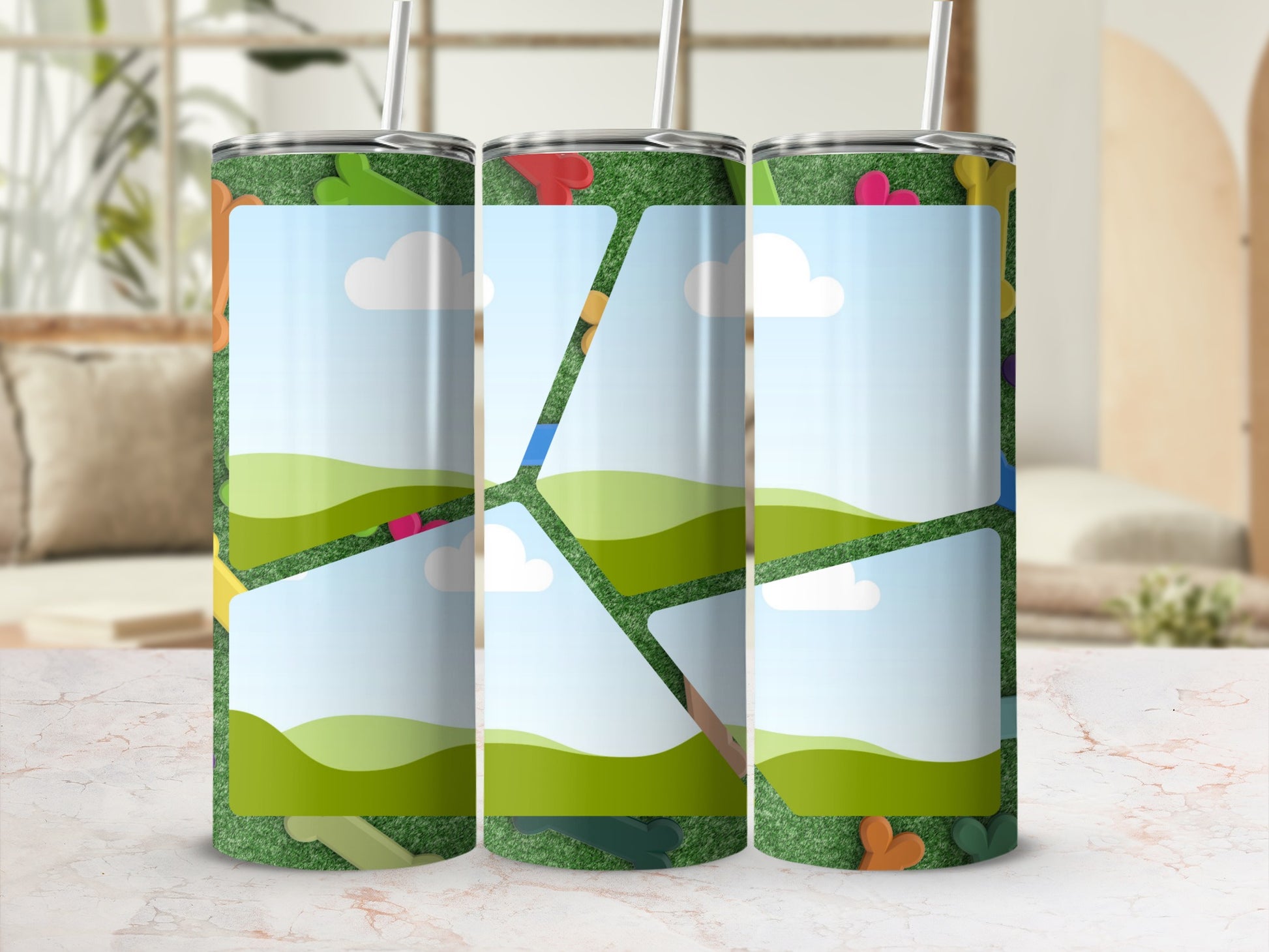 Three tumblers with a green grass design and scattered colorful pet toys.