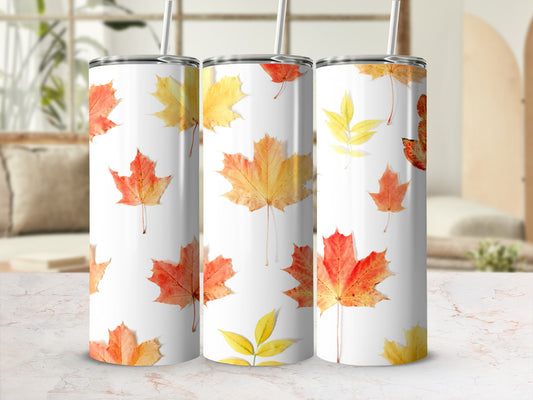 White tumblers with falling red and yellow maple leaves design.