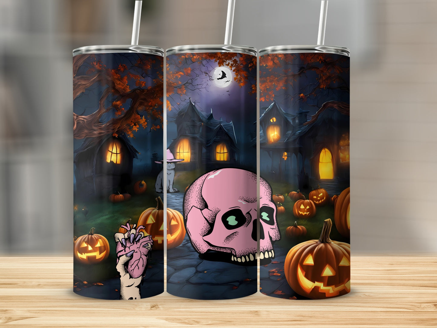 Tumbler with Halloween scene: haunted houses, pumpkins, pink skull, and hand holding a heart.