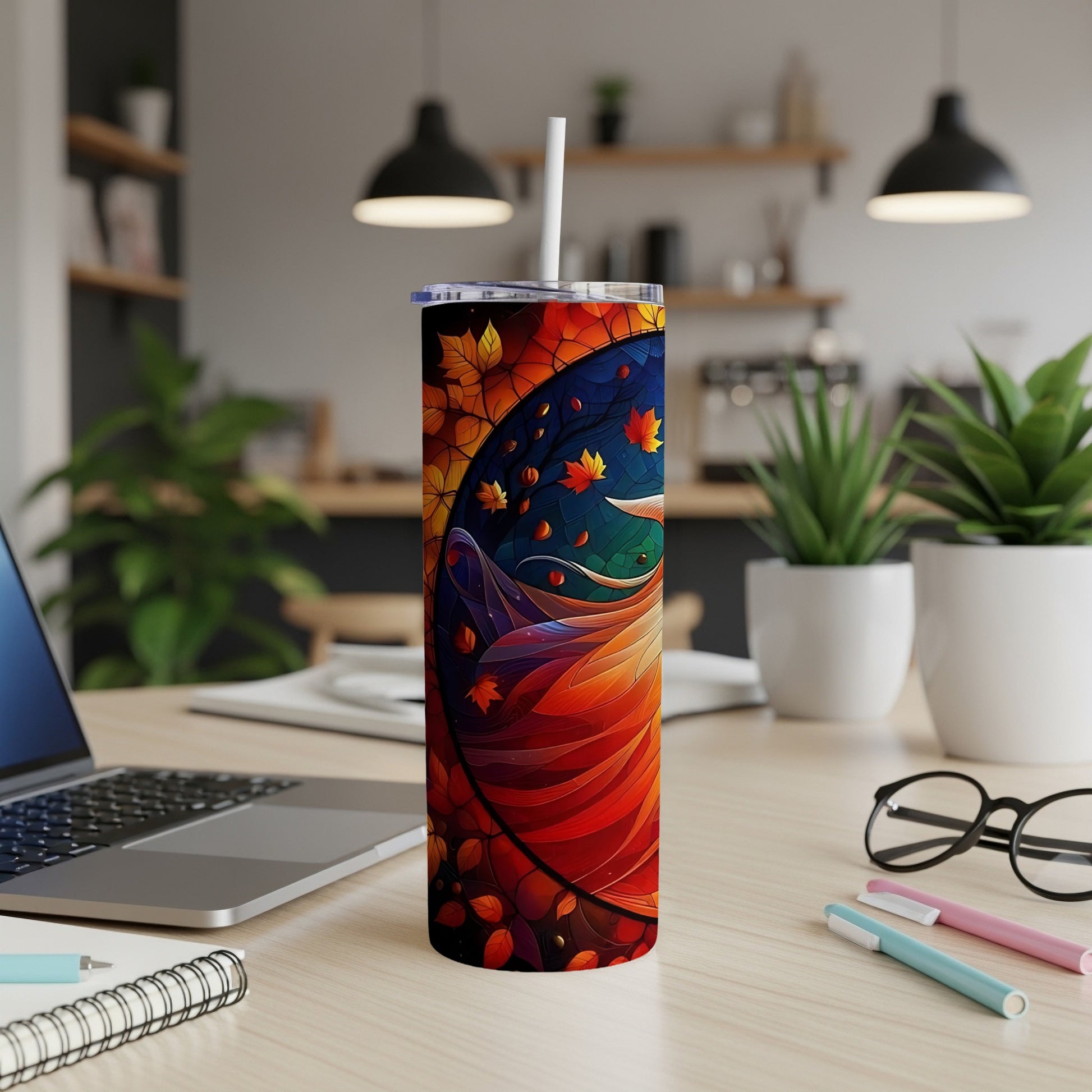 Tall tumbler with colorful abstract autumn leaves and swirling patterns.