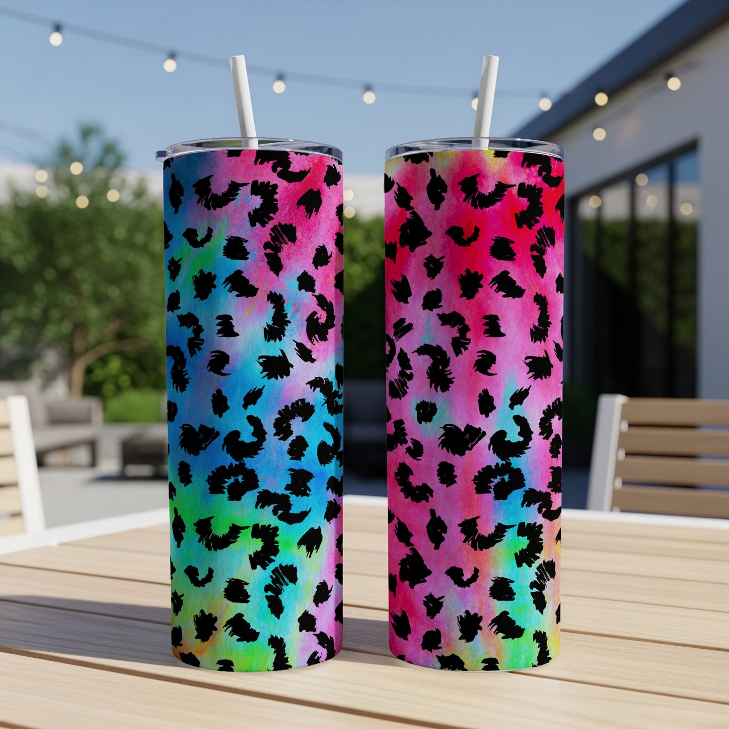 Two tumblers with black leopard print on colorful tie-dye backgrounds.