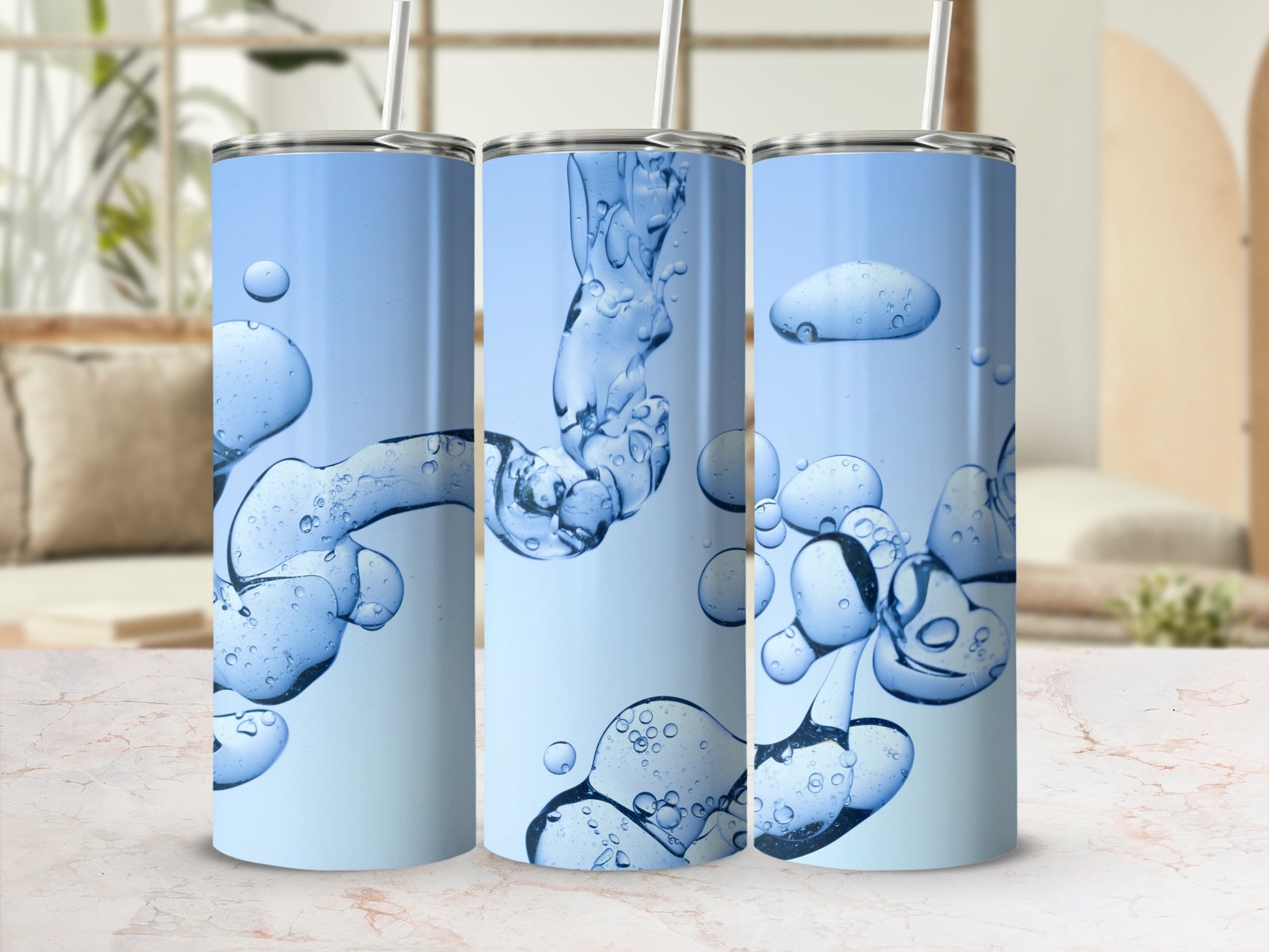 Three tall tumblers with abstract blue liquid and bubble graphics.