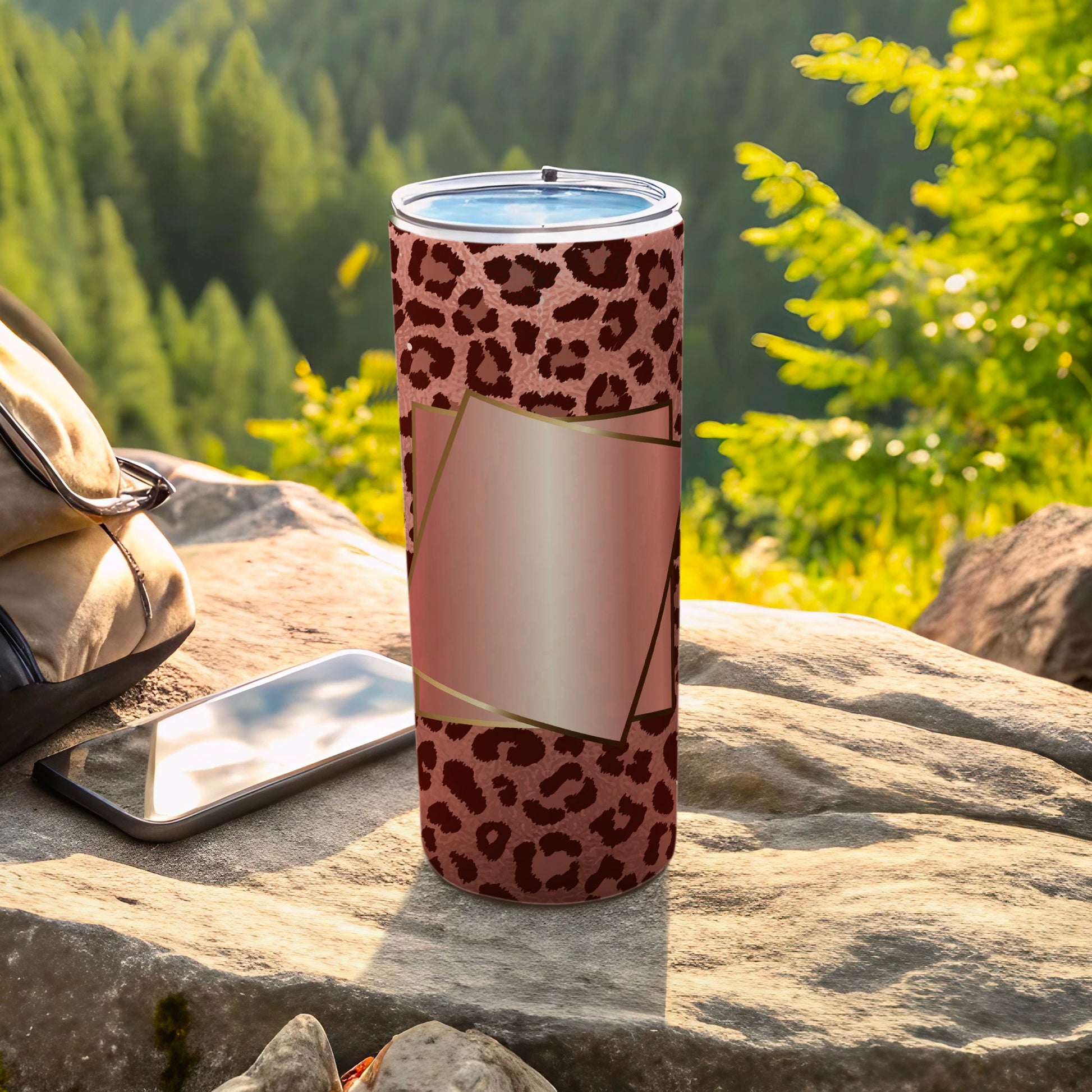 Tumbler with leopard print pattern and rose gold geometric frame outdoors.