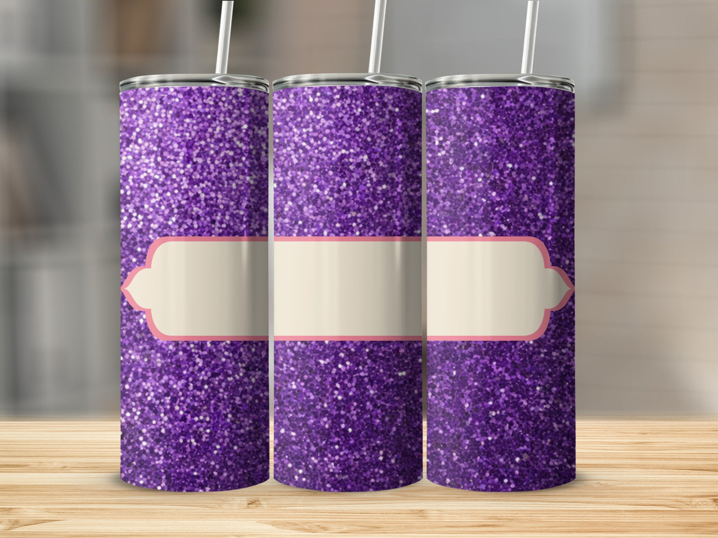 Three purple glitter tumblers with beige label design on wooden surface.