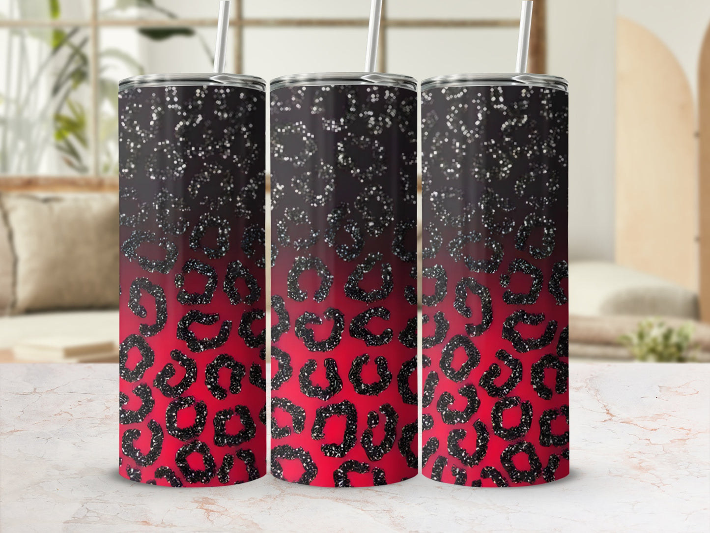 Three glittery leopard print tumblers with straws and black ombre tops.