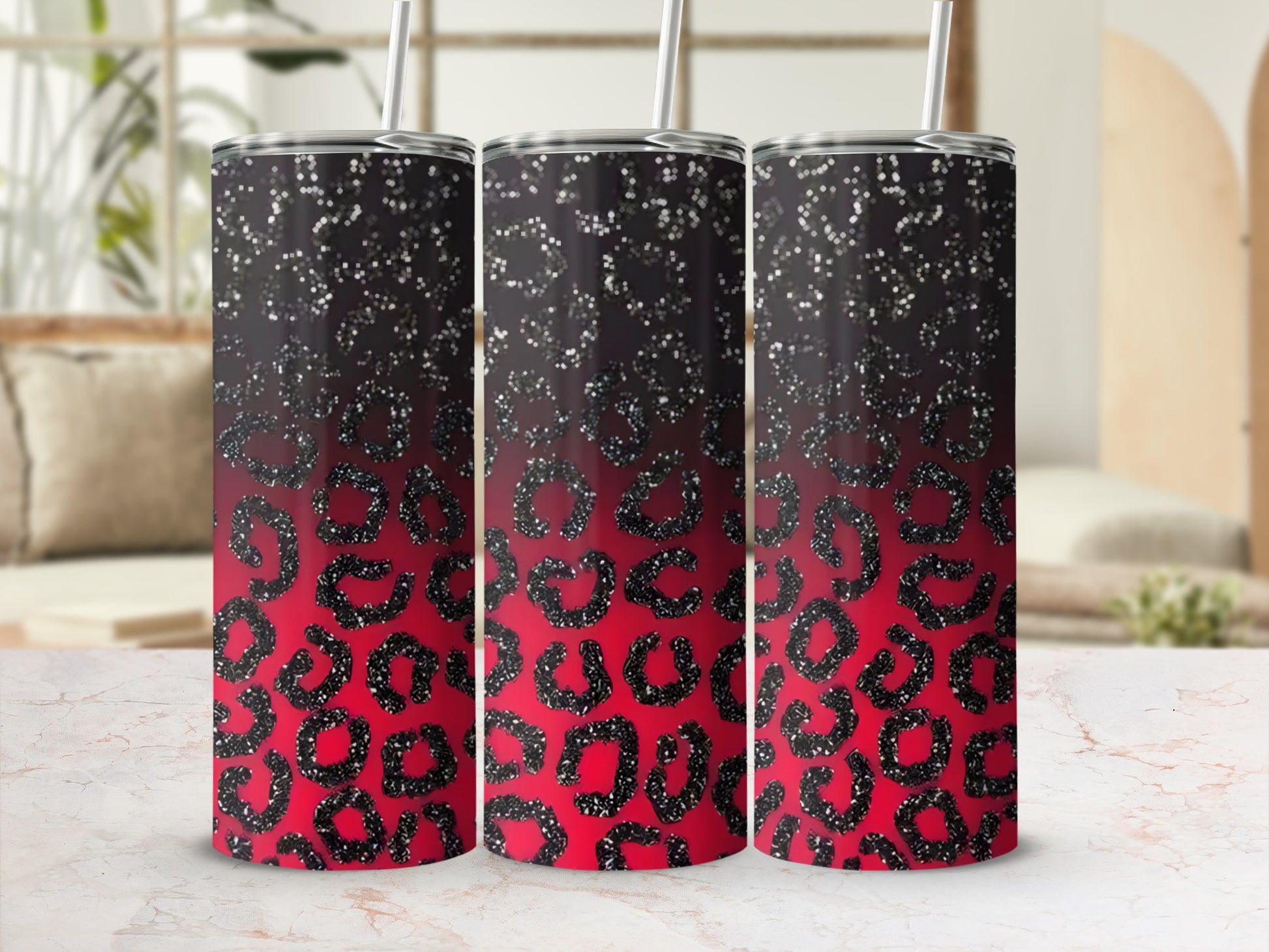Three glittery leopard print tumblers with straws and black ombre tops.