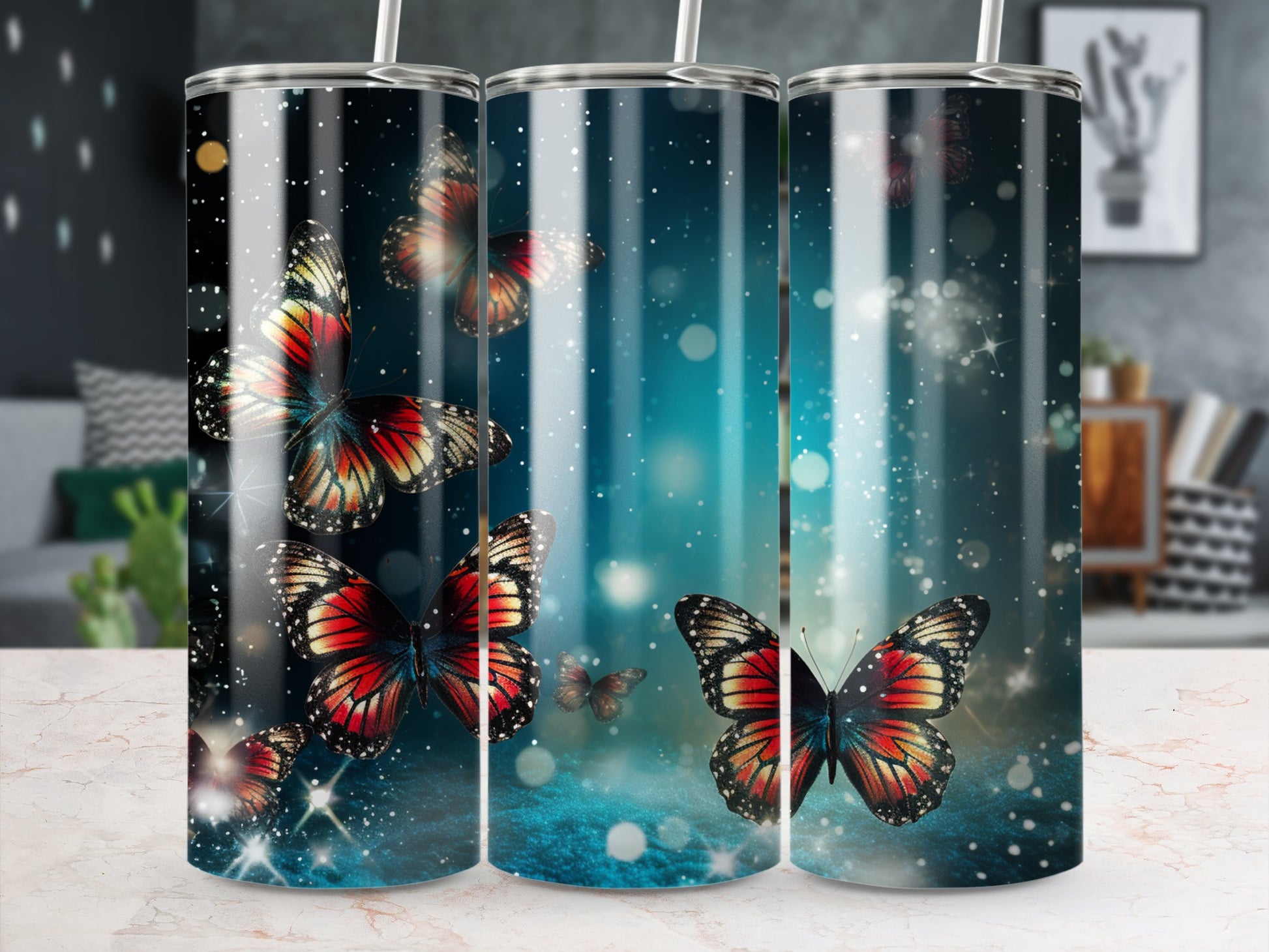 Three tumblers with colorful butterfly designs on a starry, blue background.