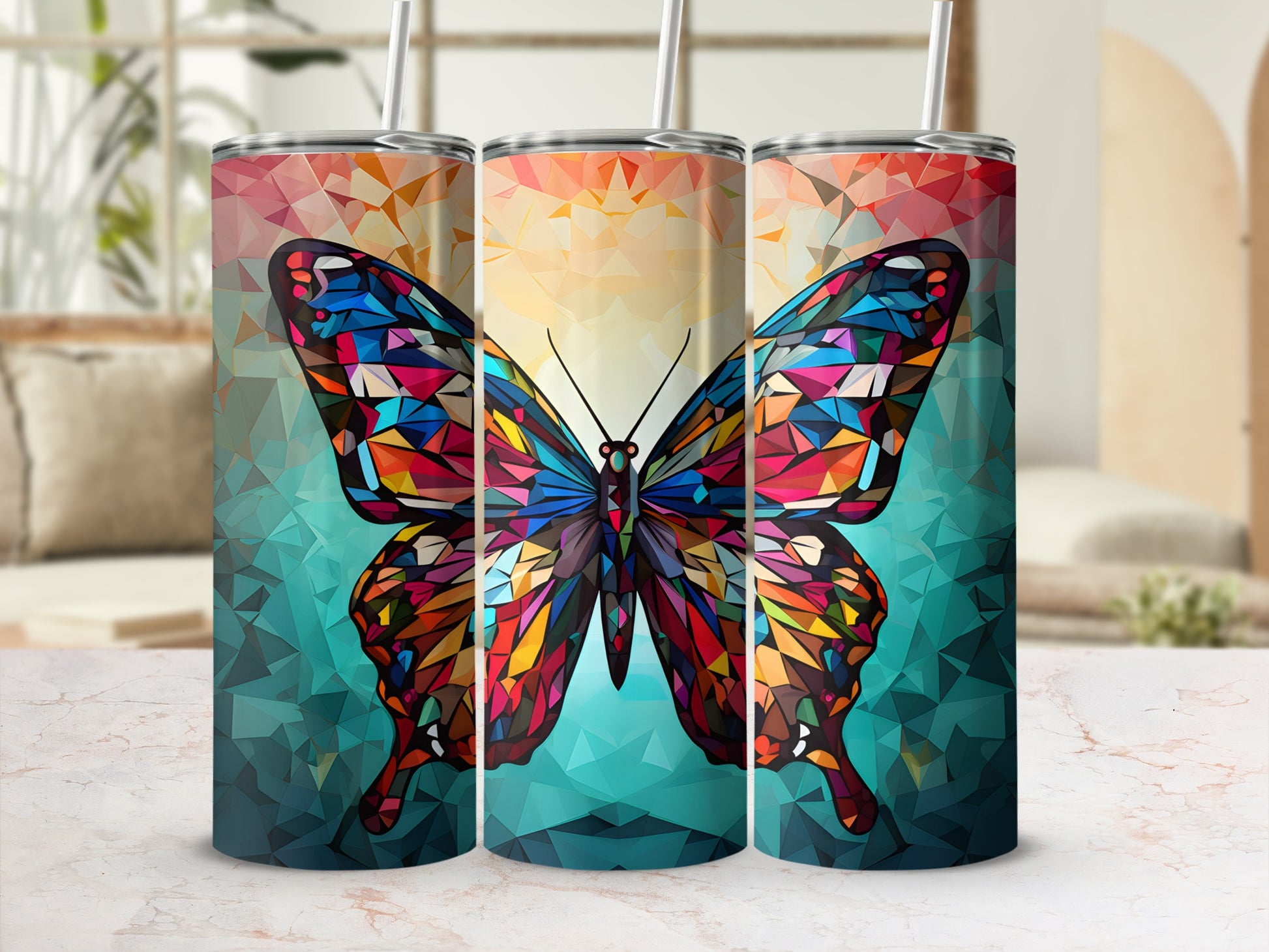 Geometric butterfly design on three colorful tumblers.
