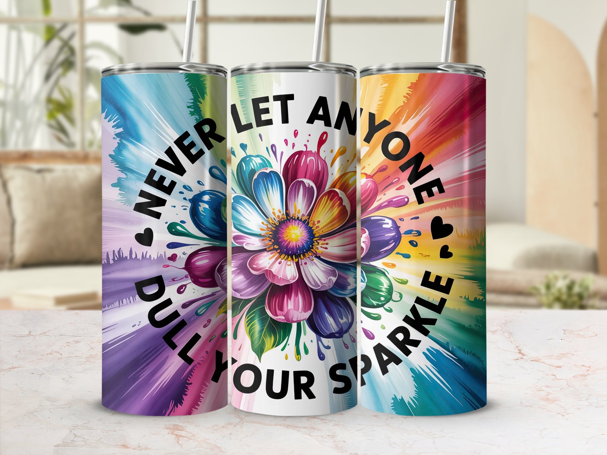 Three tumblers with colorful flower and heart designs, saying "Never dull your sparkle."