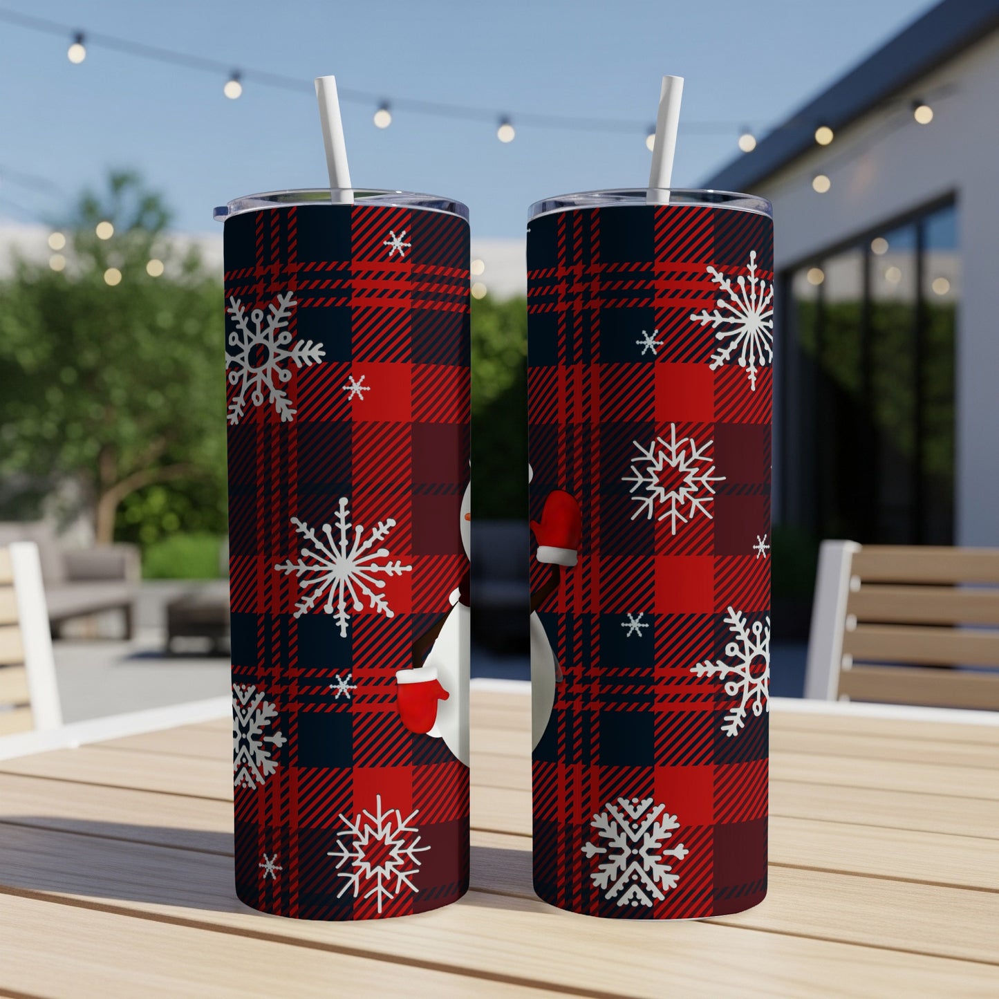 Two tumblers with a snowman and snowflakes on a red plaid background.